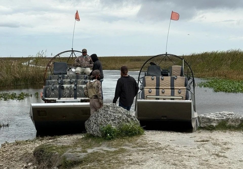 56 - Our airboat and captain, a friendly good ol' boy from the deep south, are on the left.  He was a good guide with interesting stories to share.