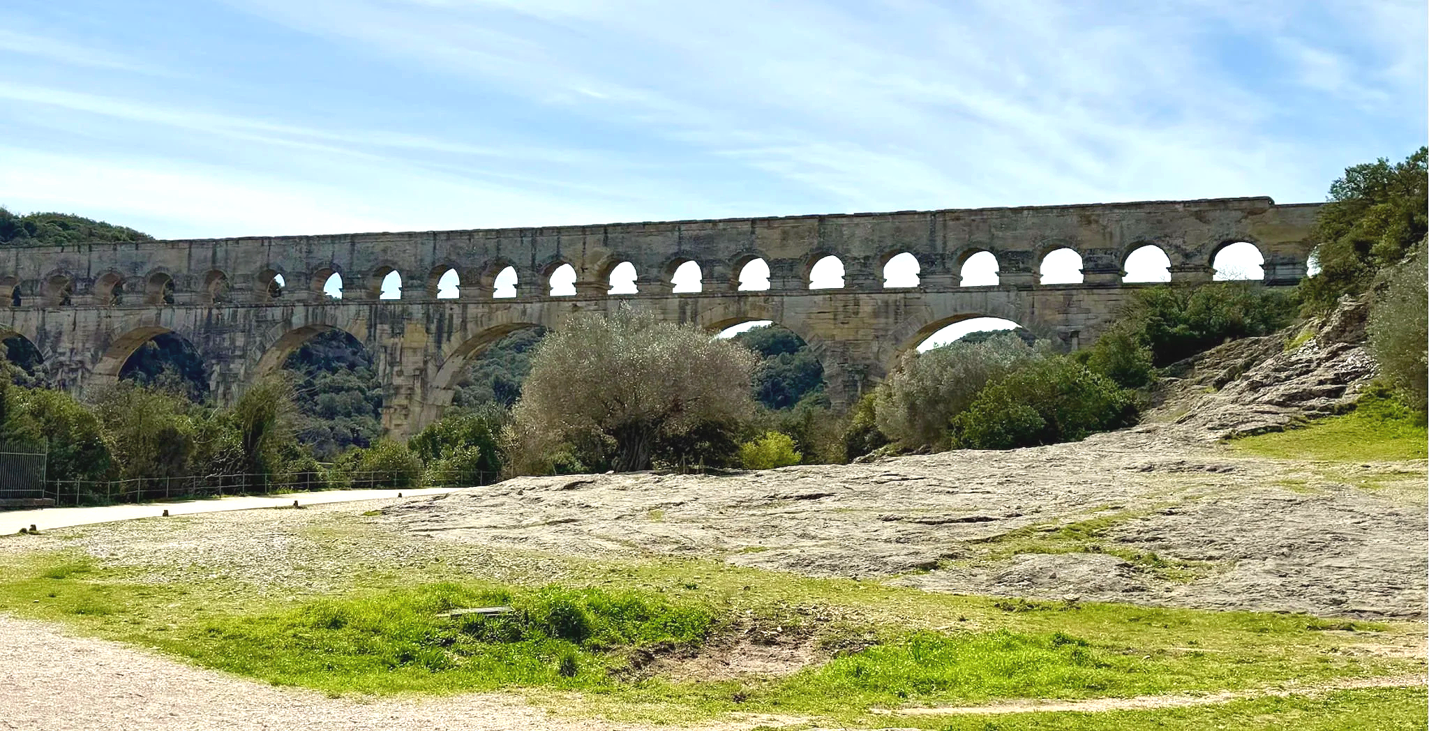 65 - The Pont du Gard is an ancient Roman aqueduct bridge built in the first century AD to carry water over 30 miles to a colony near present-day Avignon.  The aqueduct formerly carried an estimated 11,000,000 US gallons of water a day to the fountai