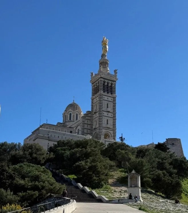 75 - Oh, sweet relief, we made it to the top! Construction of Notre-Dame de la Garde began in 1853 and lasted for over 40 years, which is about the same amount of time it took us to reach the hill's summit. 