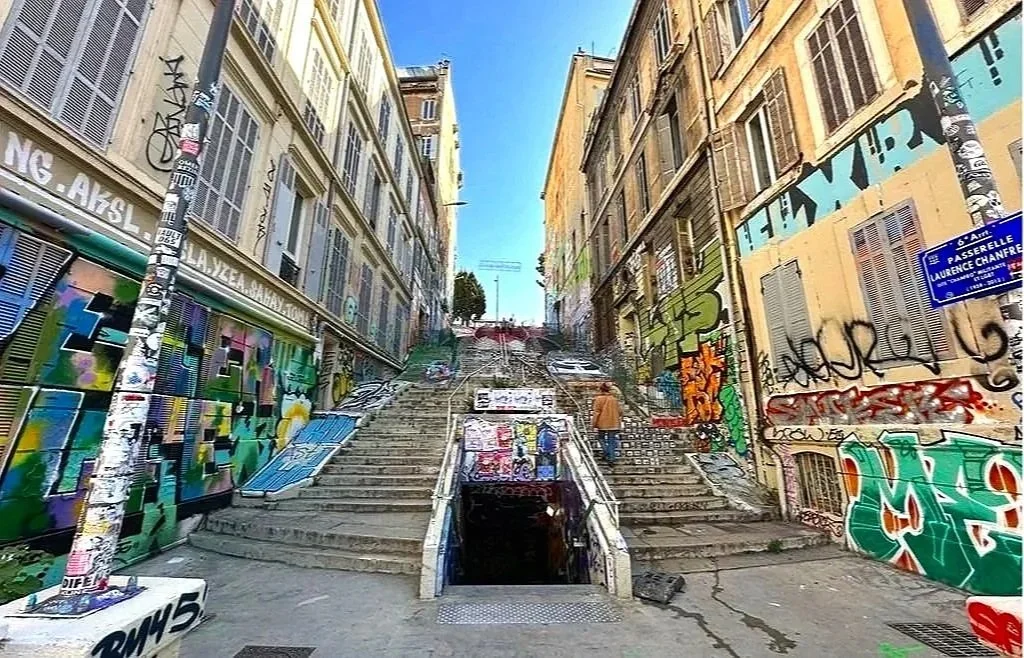 84 - Marseille has a lot of graffiti. There's also a fair amount of street art, but the graffiti tends to distract from the art. This is the Cours Julien graffiti staircase, serving as a focal point for street art in Marseille's bohemian district.