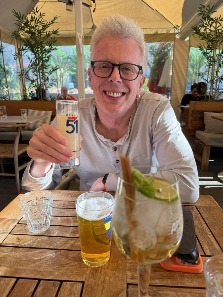 80 - Rick tried pastis after a long day of hill-climbing.  Pastis is an iconic anise-flavored aperitif deeply rooted in Marseille culture. Don't let the smile fool you, Rick was not a fan of pastis, even though he loves black licorice -- this stuff i