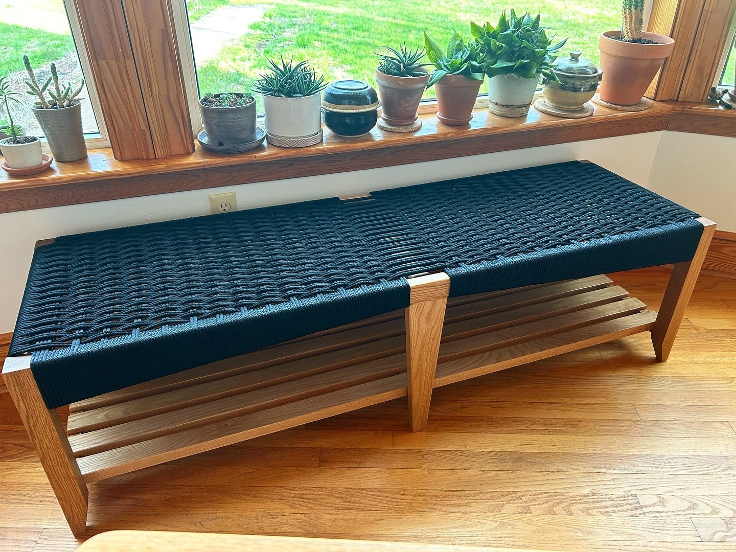 Big woven bench in white oak and black rope with a shelf underneath