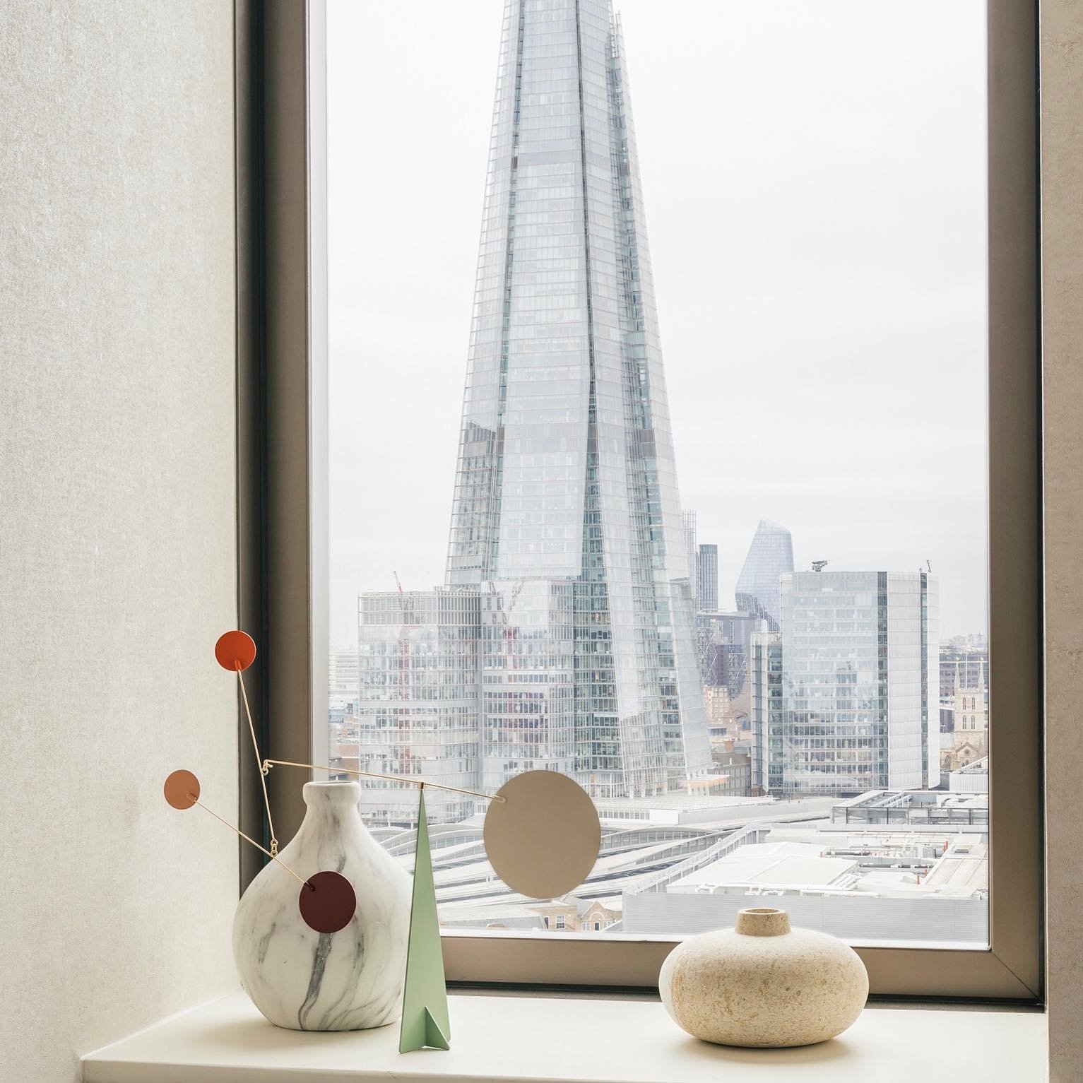 One of the many views from our One Tower Bridge project. 
Accessories are a great way of adding additional interest to a otherwise redundant space, such as a window sill. 
This carefully built mobile by Volta @theconranshopofficial reflects its backg