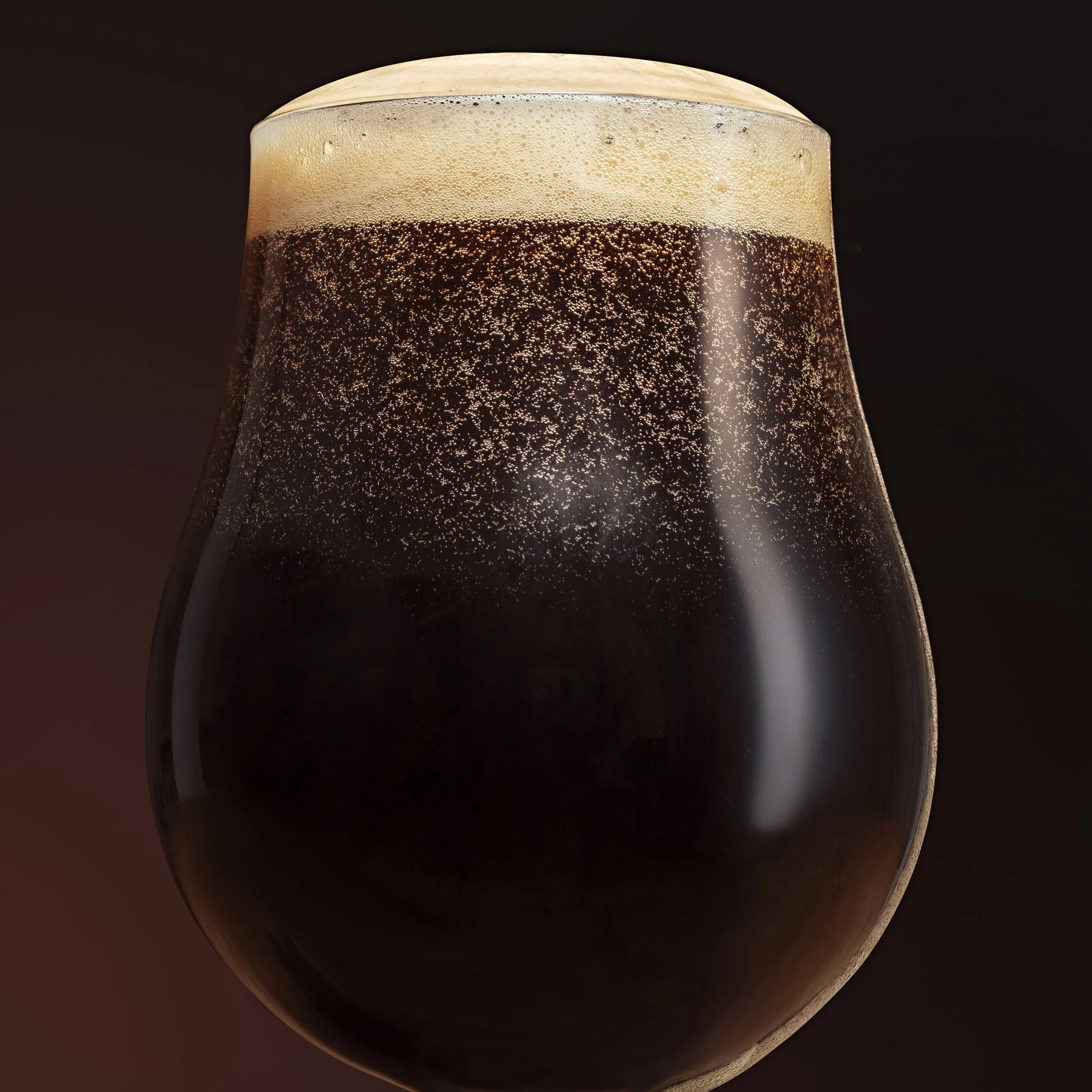 Close-up of a glass of dark beer with foam on top, set against a dark background.