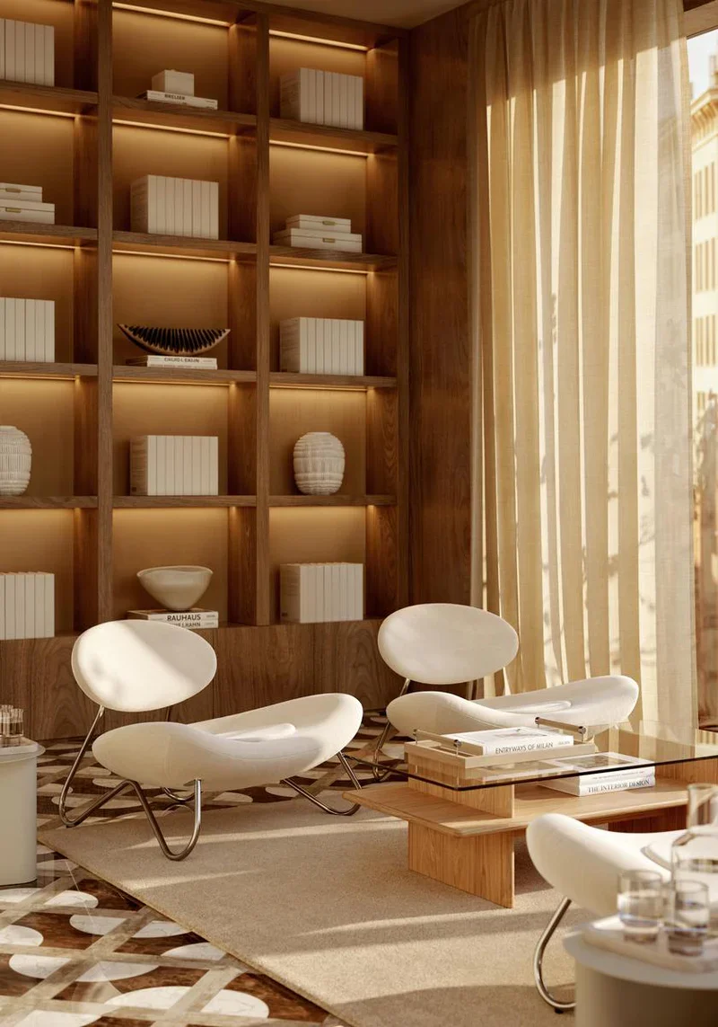 Modern interior space featuring a wooden bookshelf with decorative objects and books, large window with curtains, and white lounge chairs arranged around a wooden coffee table.
