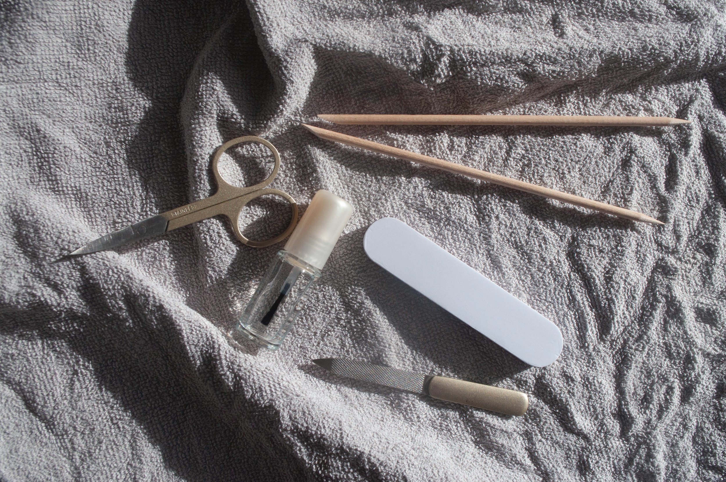 Manicure tools on a gray fabric background