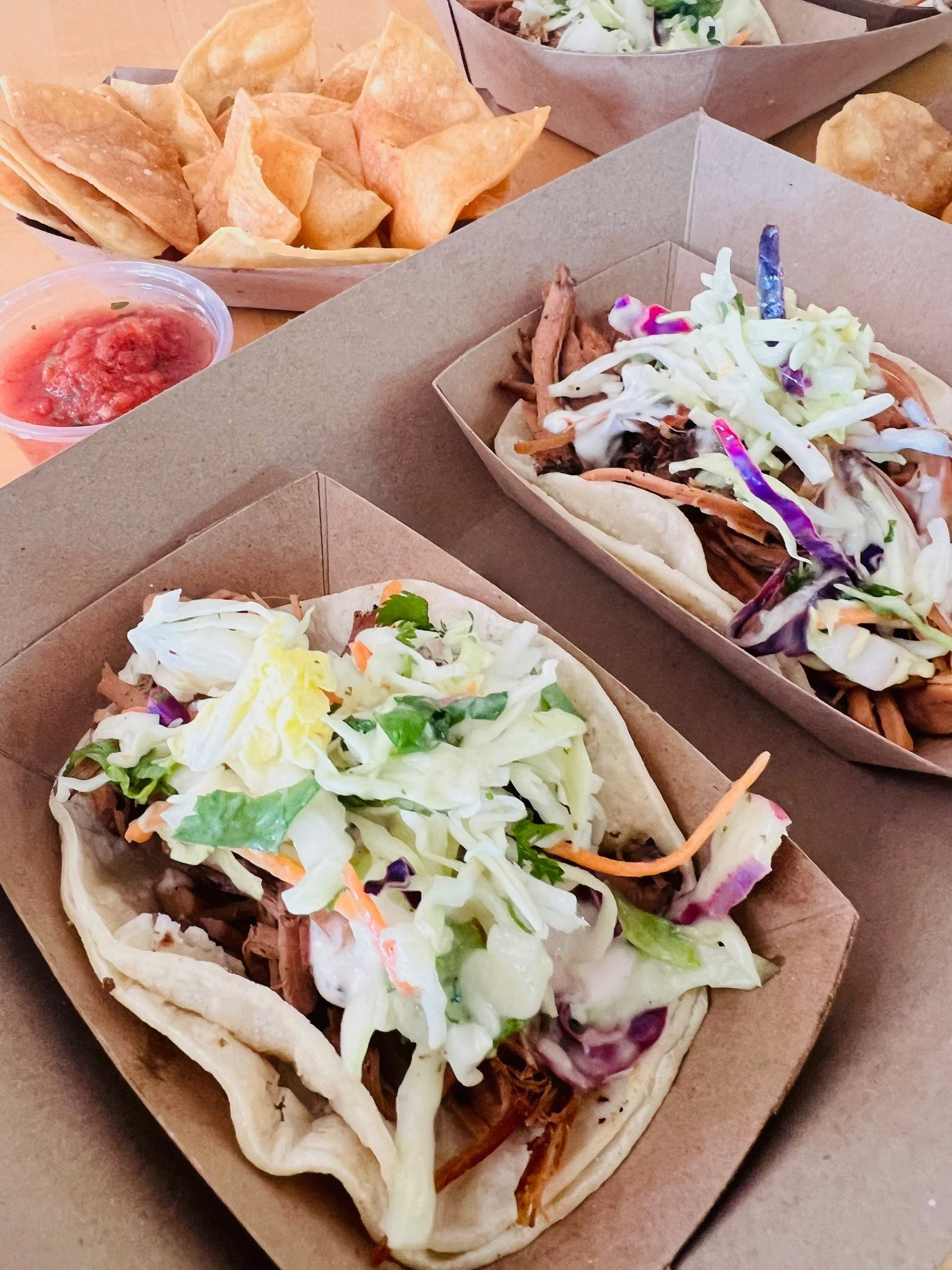 Image of beef brisket taco, with chips and salsa for catering orders.