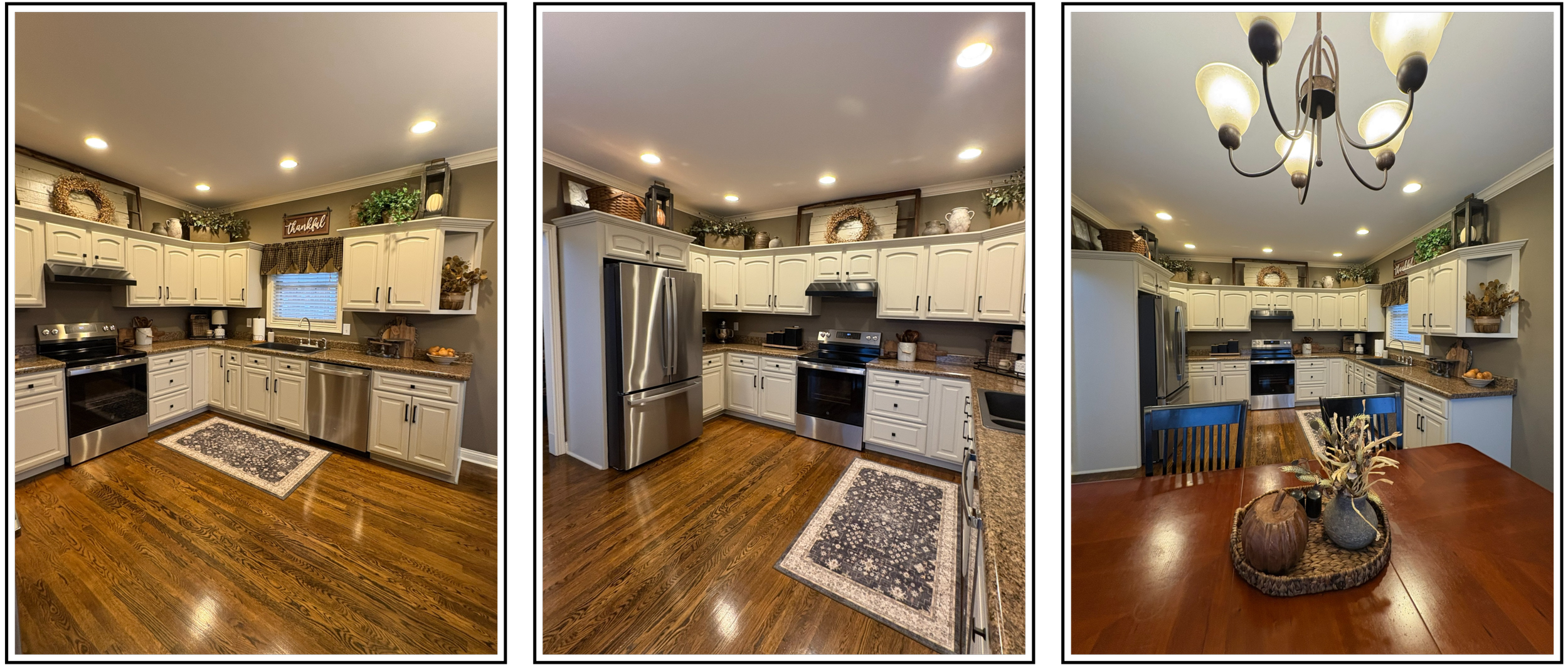 A panoramic view of a kitchen with white cabinets, stainless steel appliances, wooden flooring, and decorative plants and dishes on top of the cabinets. The kitchen features a window with a valance above the sink and a dining table with a centerpiece of candles and vases.