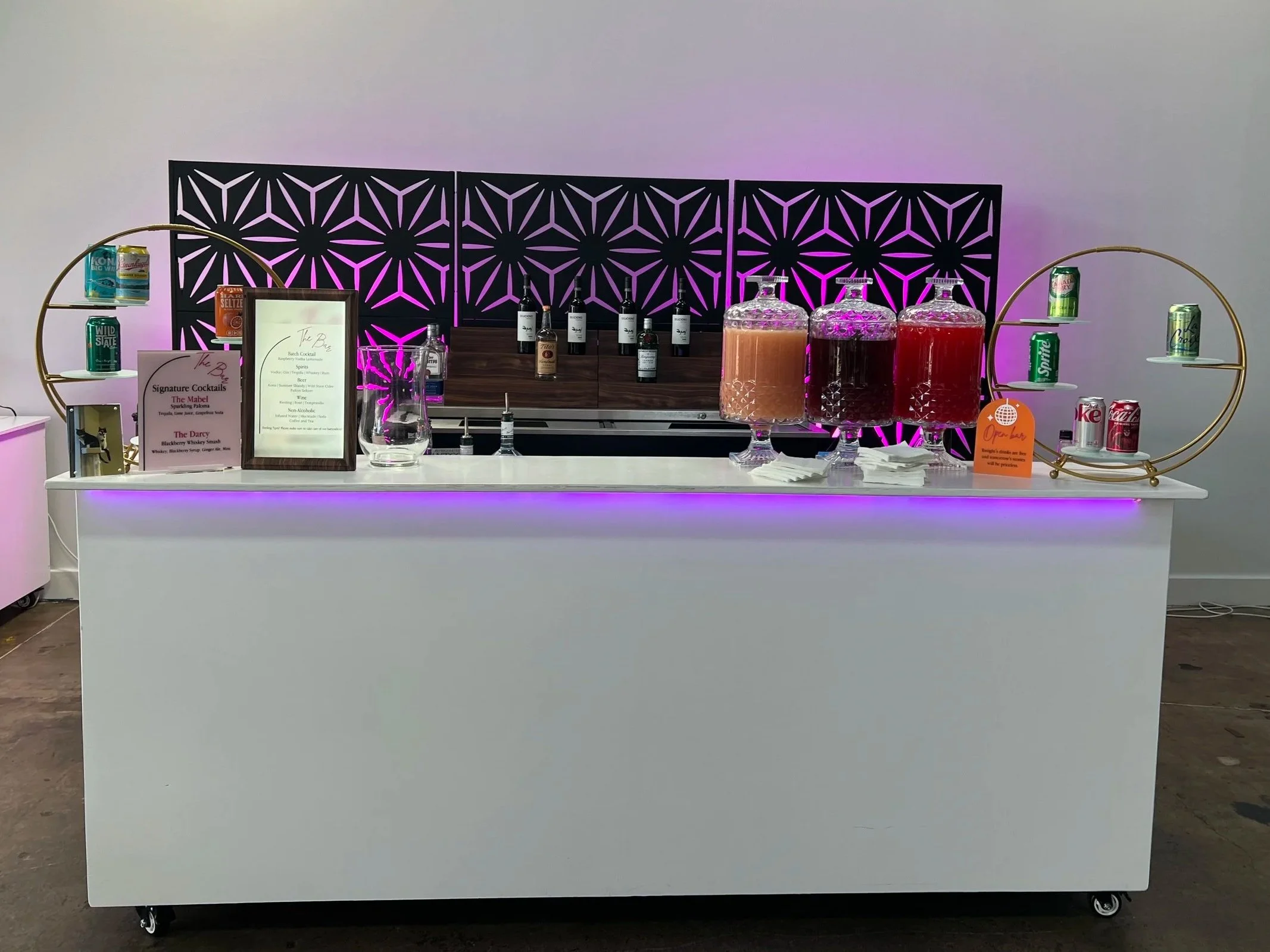 One of the 8' bars used for a beverage station.  With batched cocktails in glass dispensers.