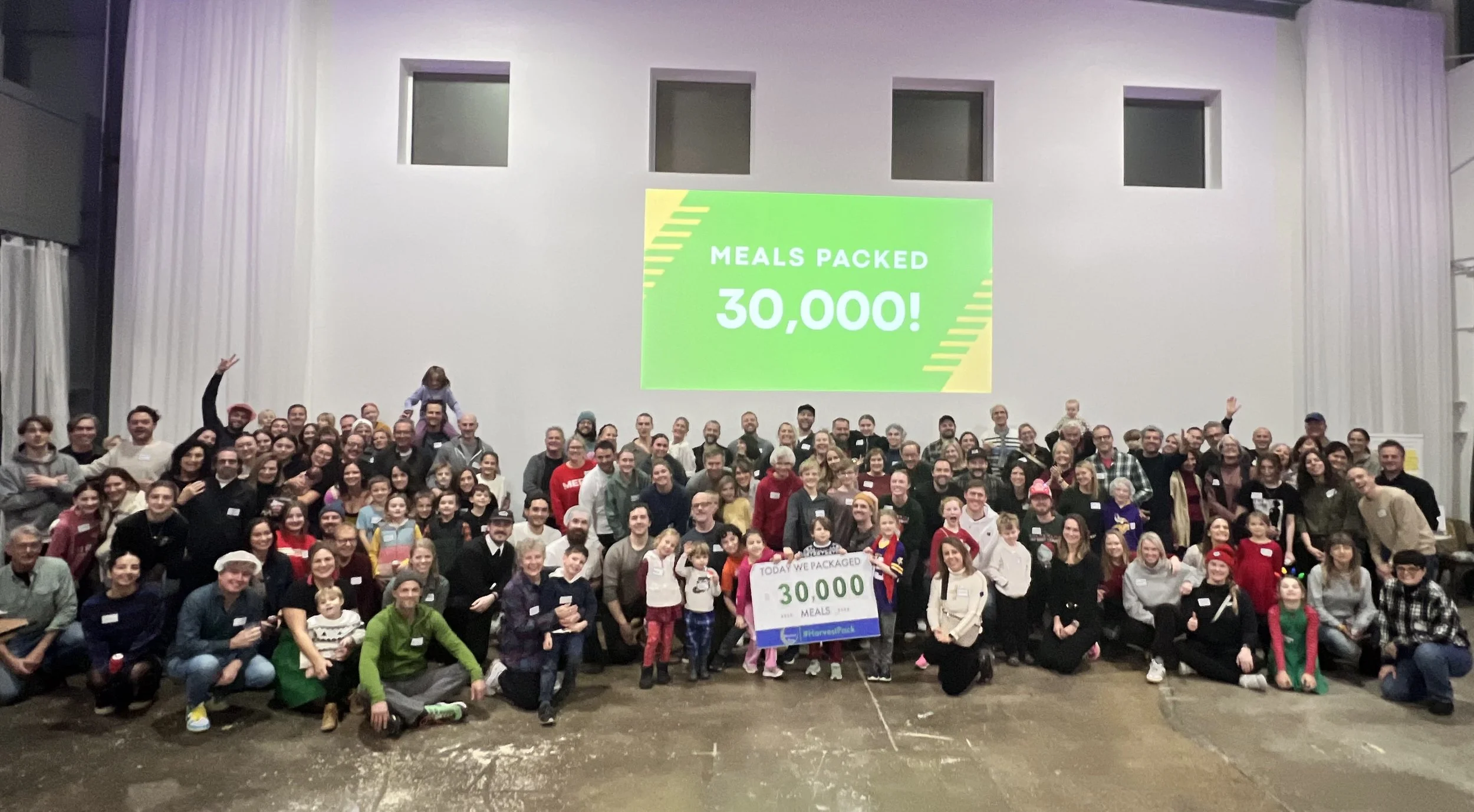 Group of about 120 friends and family that packed 30,000 meals for Harvest Pack