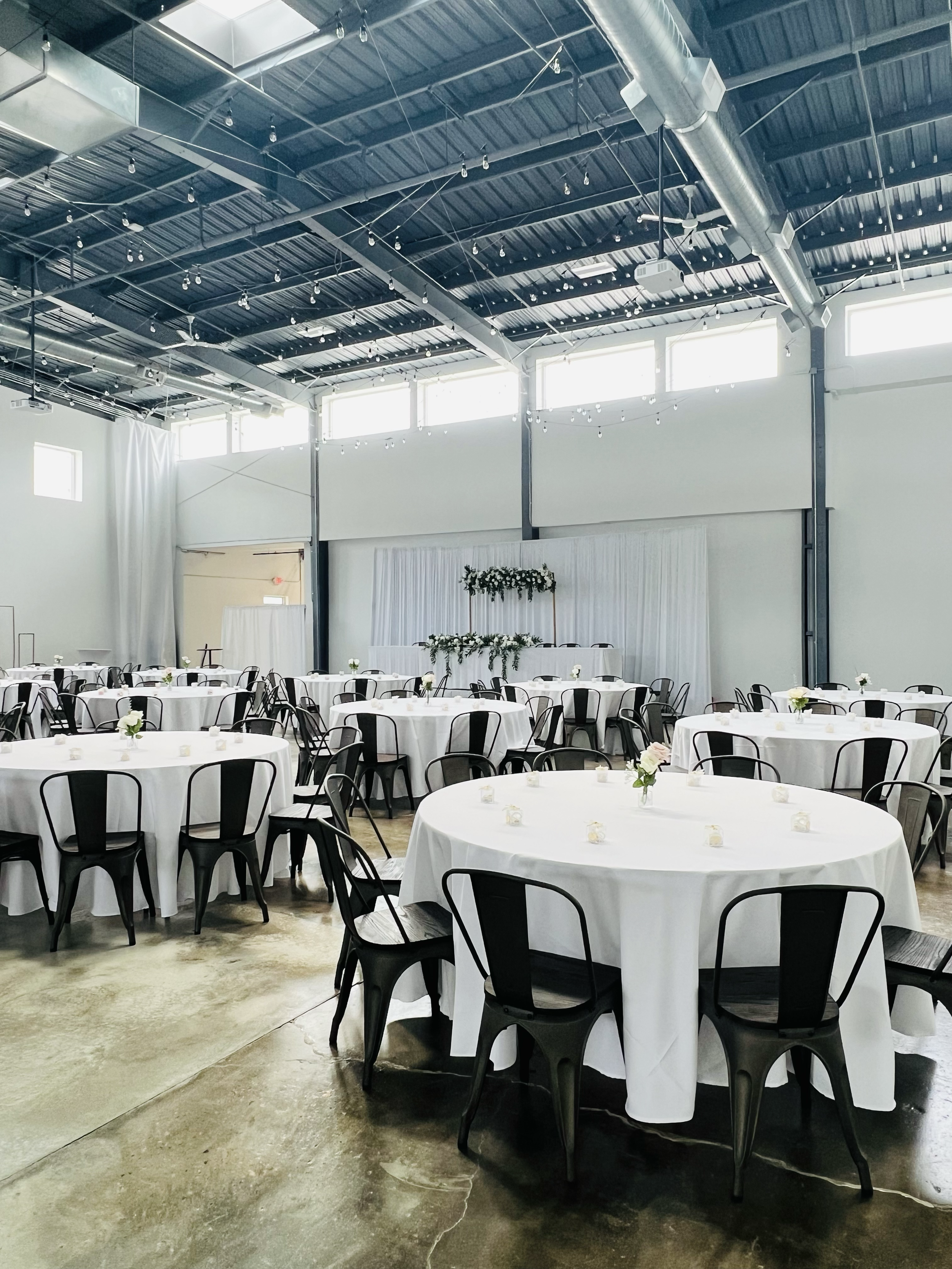 Simple white Nikkah ceremony backdrop, with natural sunlight in large open space.
