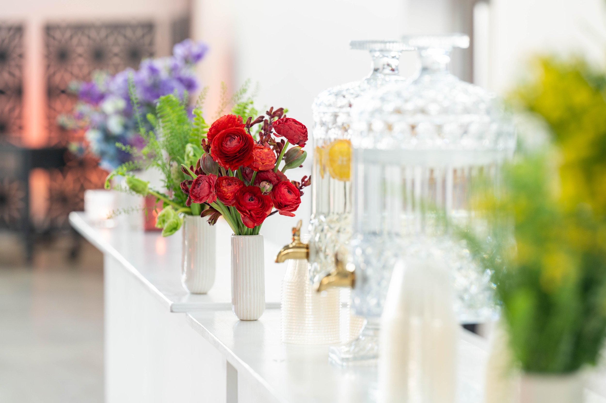 Day time corporate luncheon in Minneapolis, glass dispensers with infused waters and bright florals.