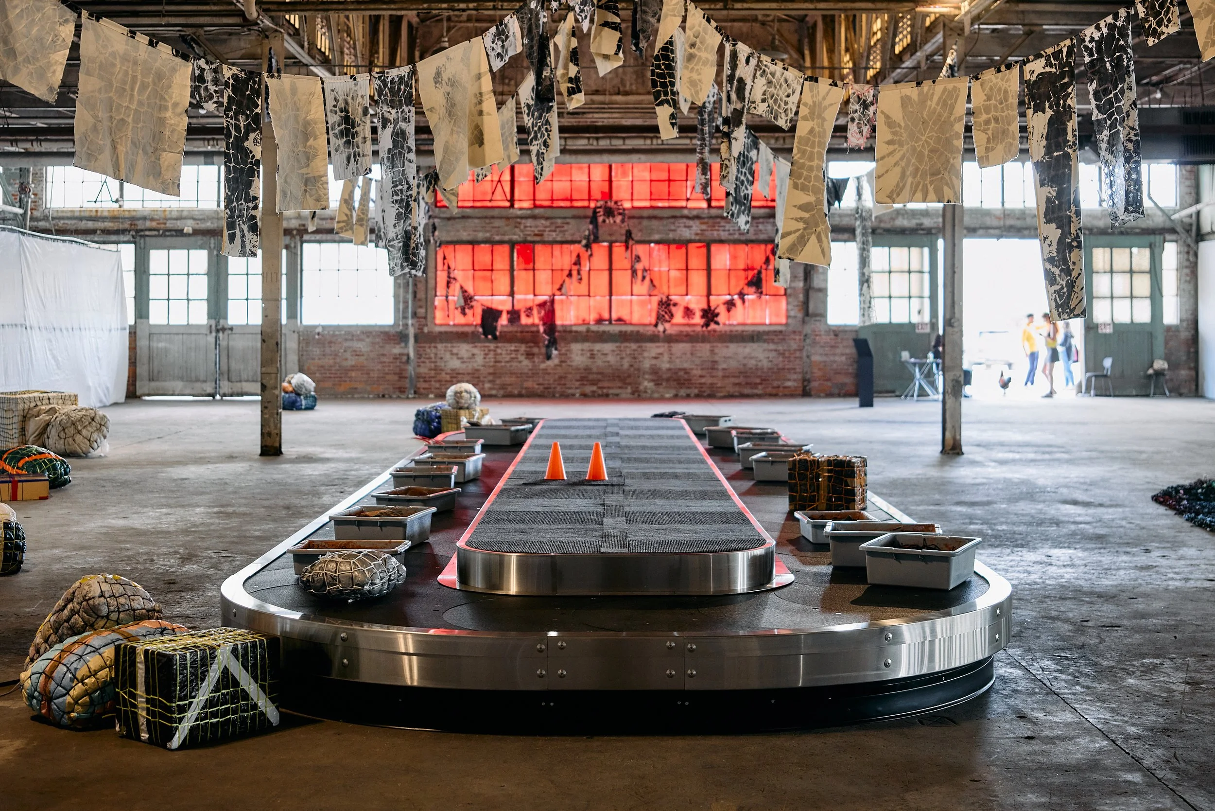 Maia Ruth Lee

The Conveyor, 2024
Flat plate carousel, plastic tote trays, mud, ceramic, found objects, rope, ink, canvas, and mixed media sculptures 