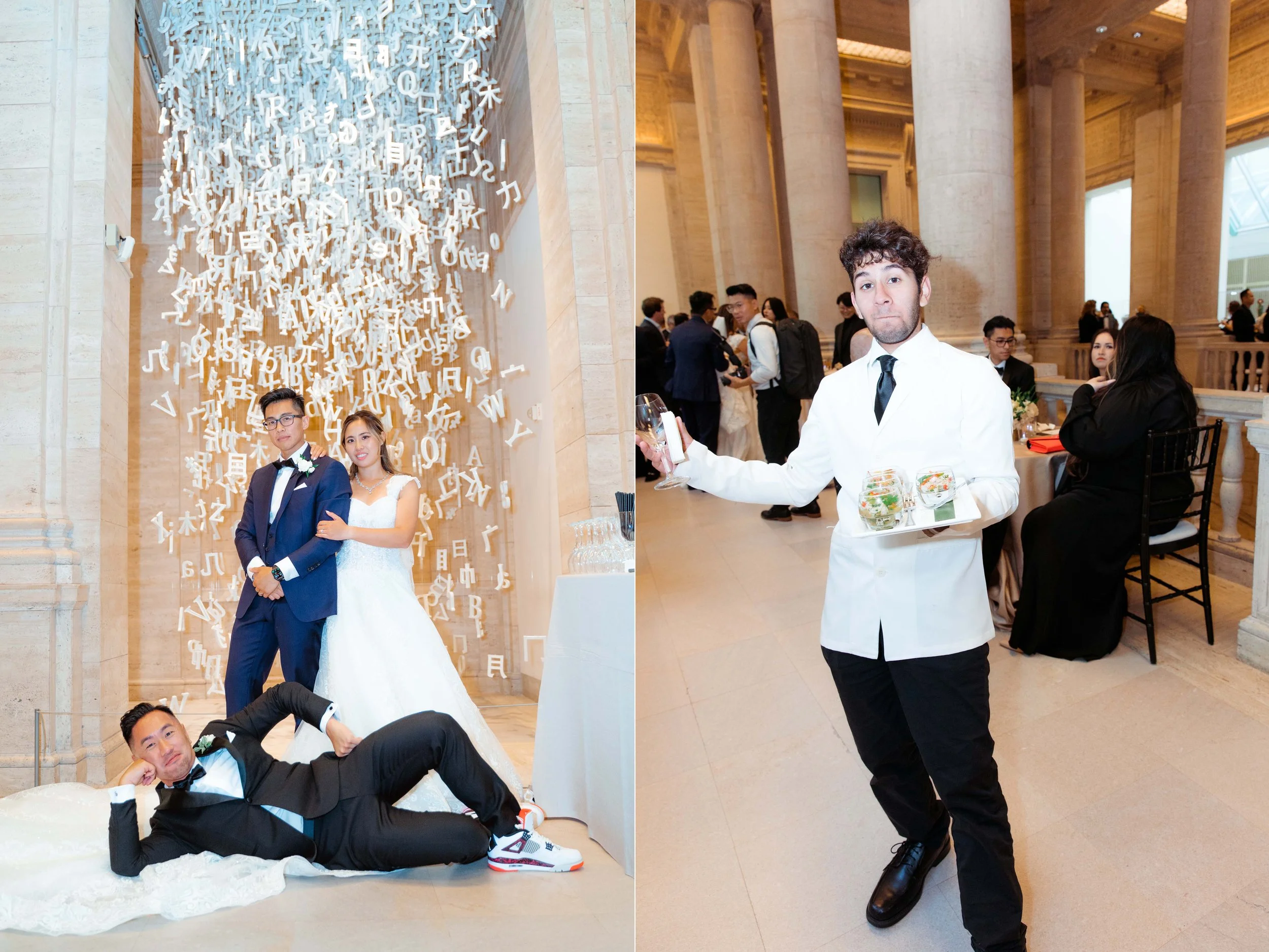 A wedding celebration with a bride and groom posing under a hanging installation of white letters and symbols, while a waiter in a white jacket serves drinks in an elegant venue with tall columns and groups of guests seated at tables in the backgroun