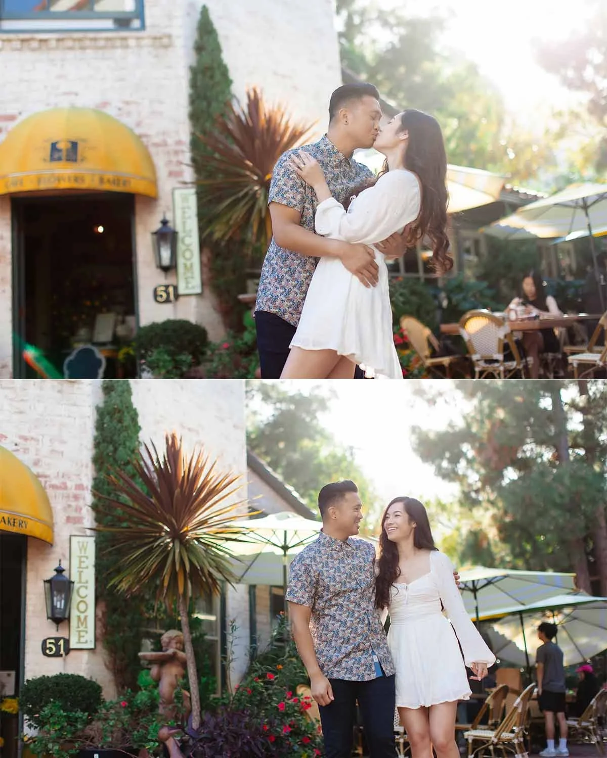 A young couple sharing a kiss and smiling at each other outside a cafe with outdoor seating.