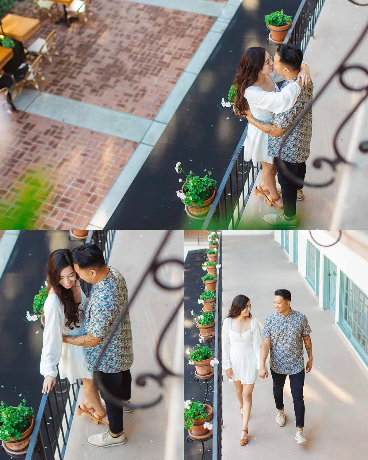 A young couple sharing a kiss and holding hands on a balcony with potted plants, overlooking a brick courtyard and walkway.