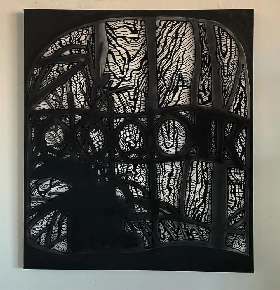 Silhouette of a tree and a bird within a decorative cutout design.