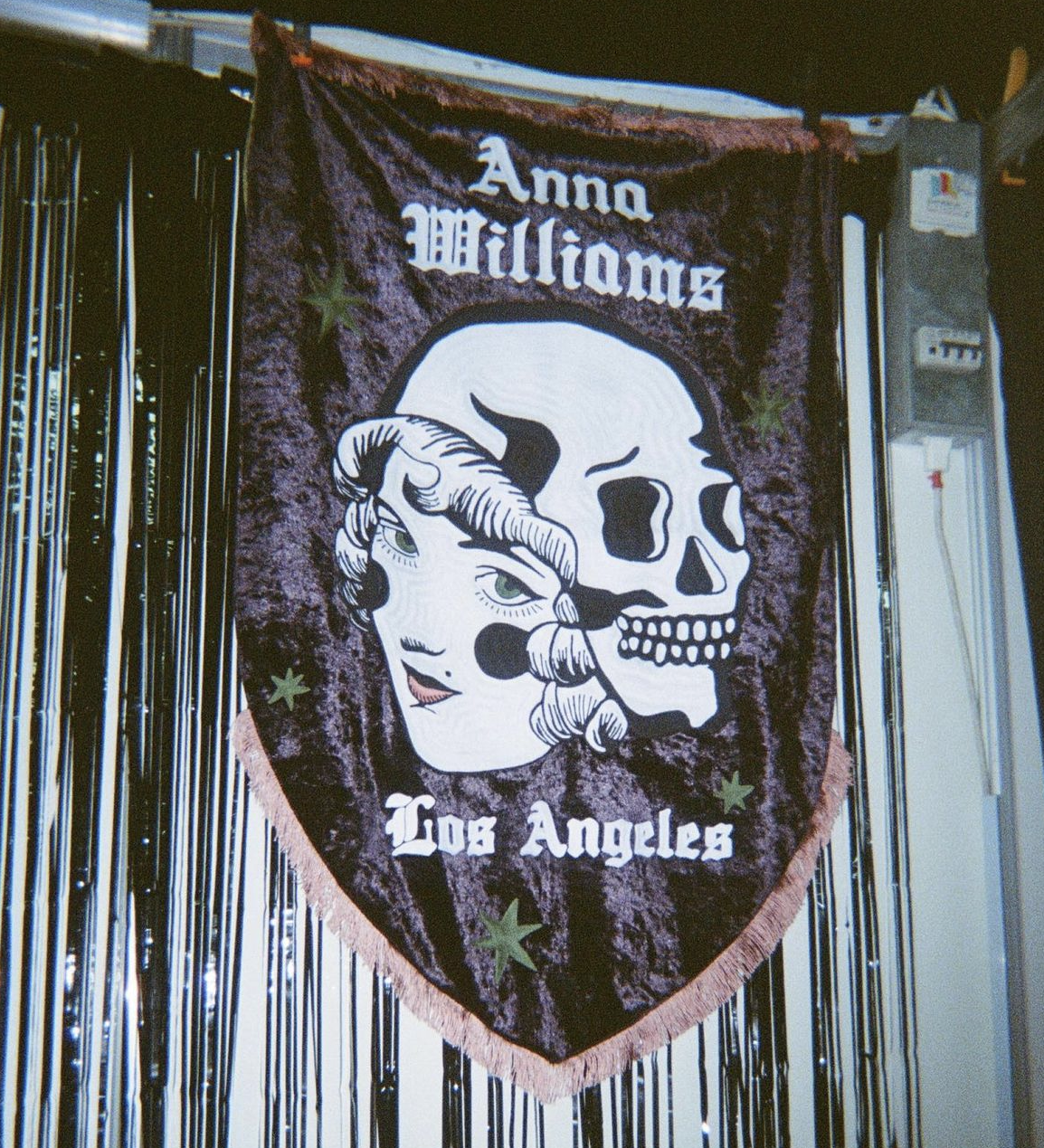 Chainstitched banner with a skeleton and a woman's face, labeled 'Anna Williams' and 'Los Angeles'.