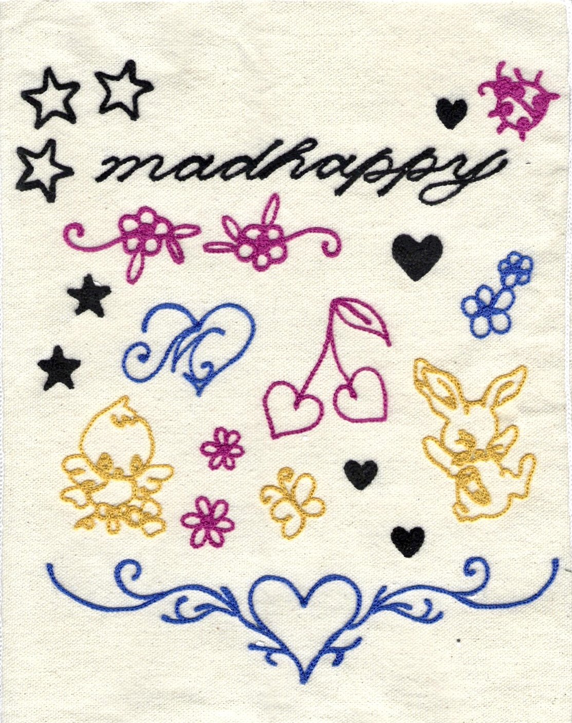 Embroidery with the word 'makeapsey' surrounded by colorful hearts, flowers, stars, bunnies, and decorative swirls on fabric.