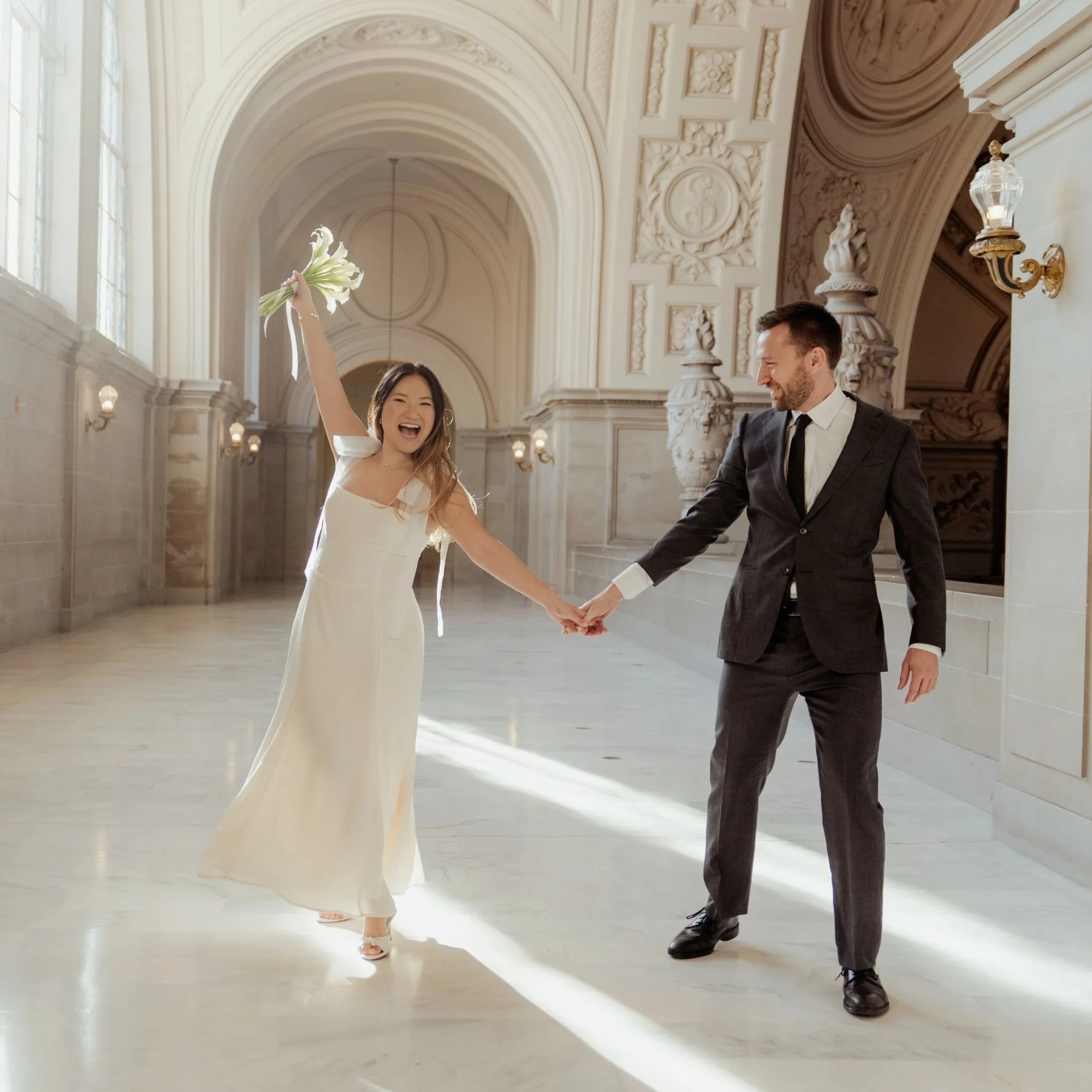 Playful photo of a couple at San Francisco City Hall during a courthouse wedding ceremony