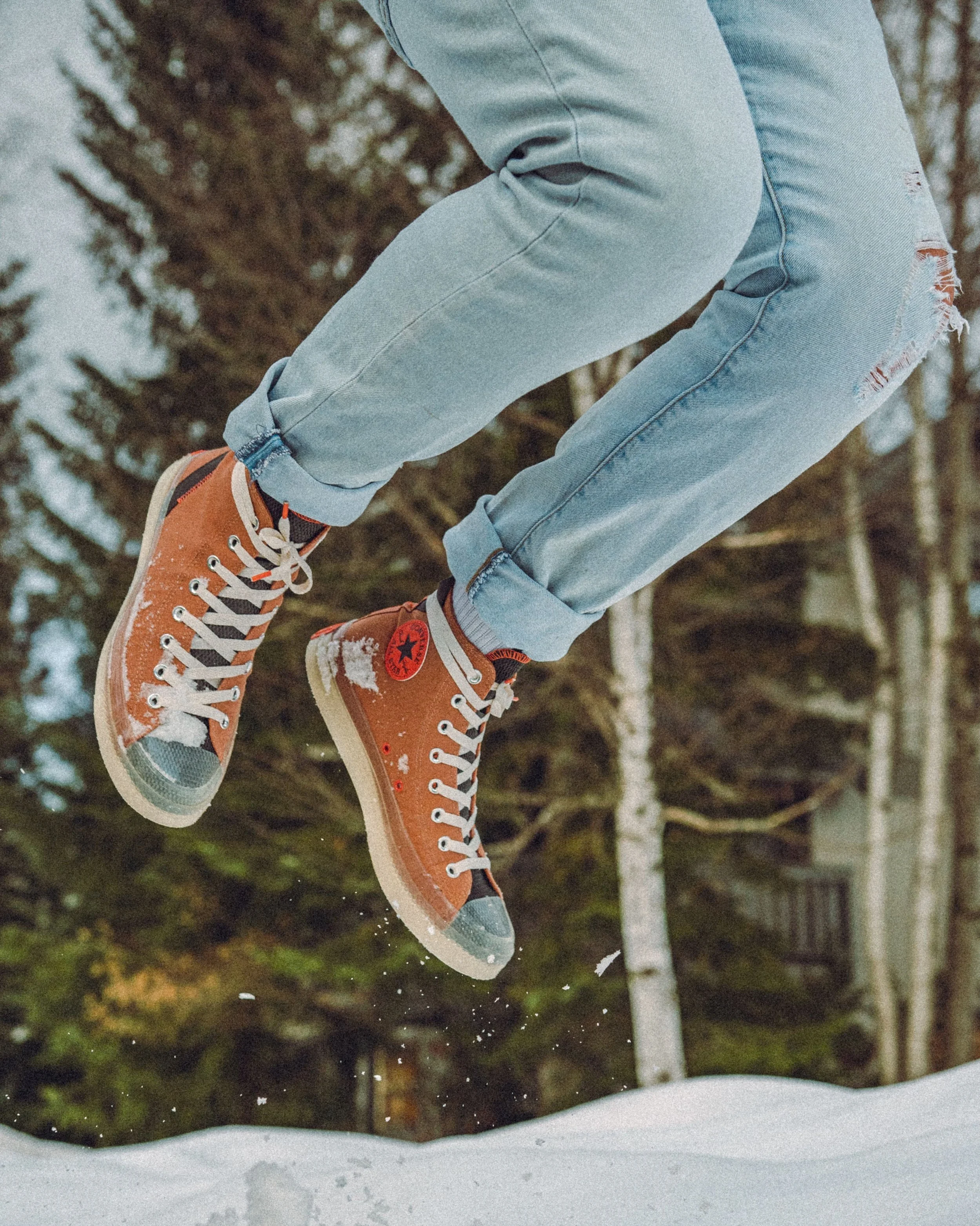 Orange Converse Jumping in Snow