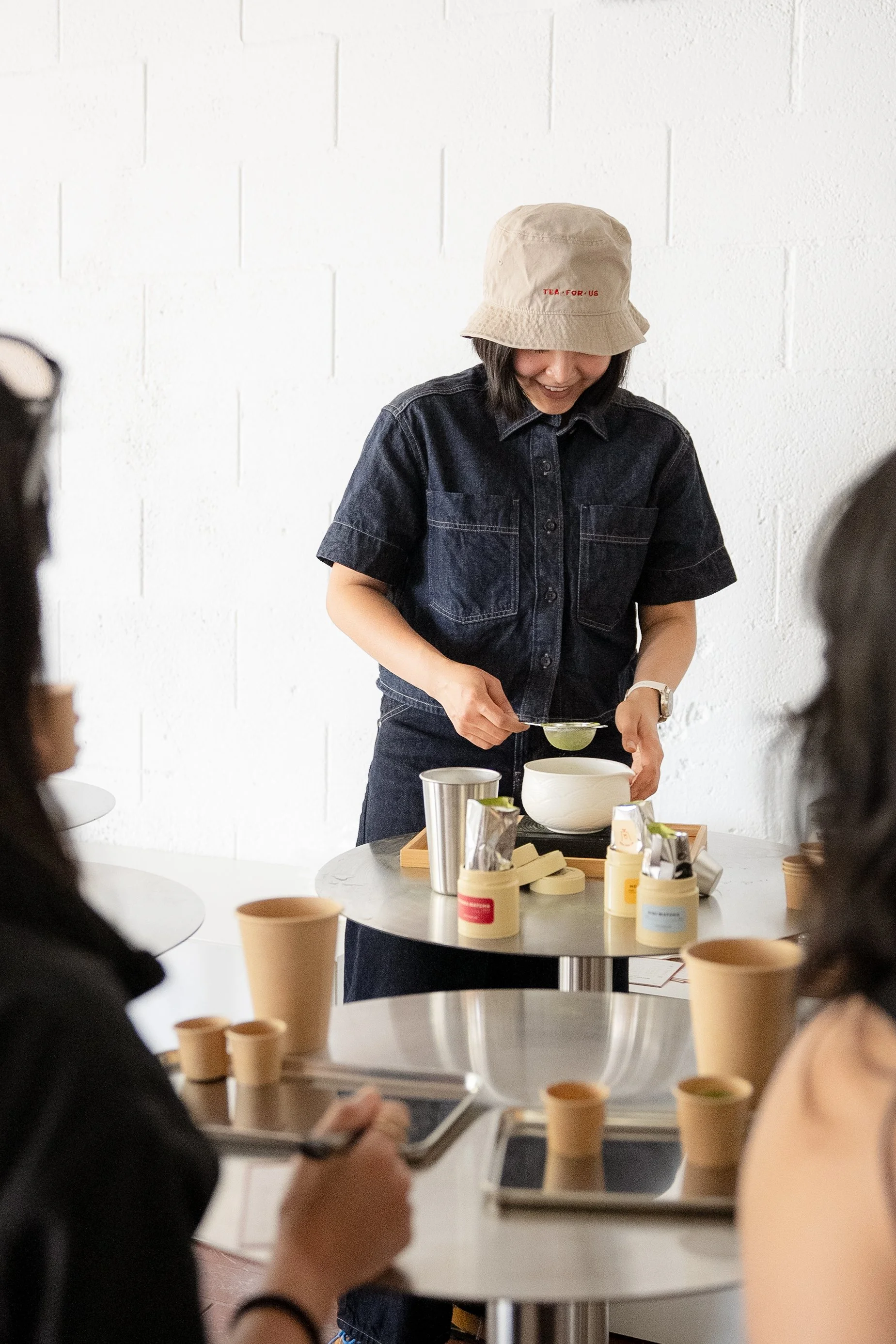 Brand owner preparing matcha during a Tea For Us brand activation pop-up with Kindred Studio in San Francisco