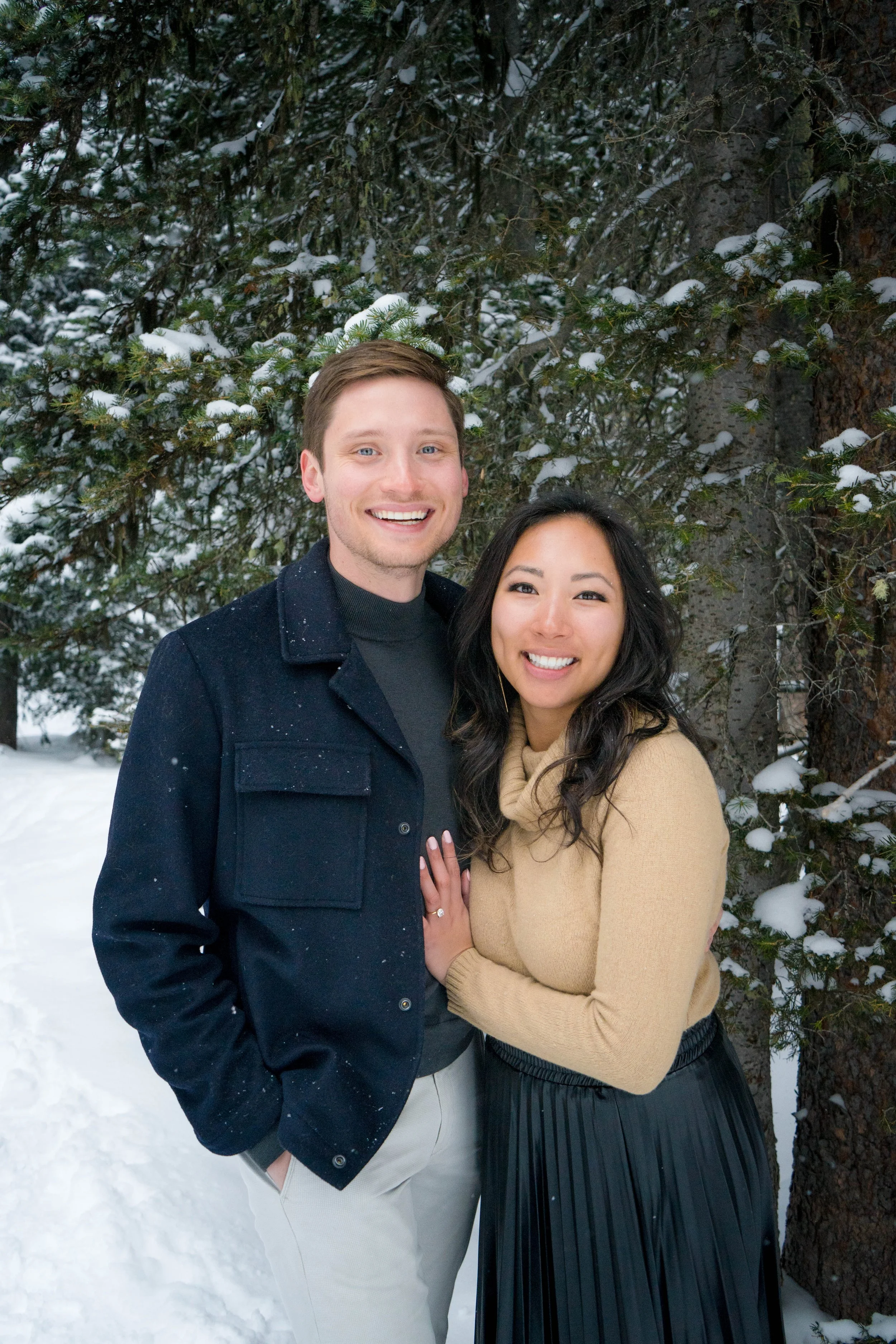 Engagement couple portrait in a snowy forest in Steamboat Springs, Colorado