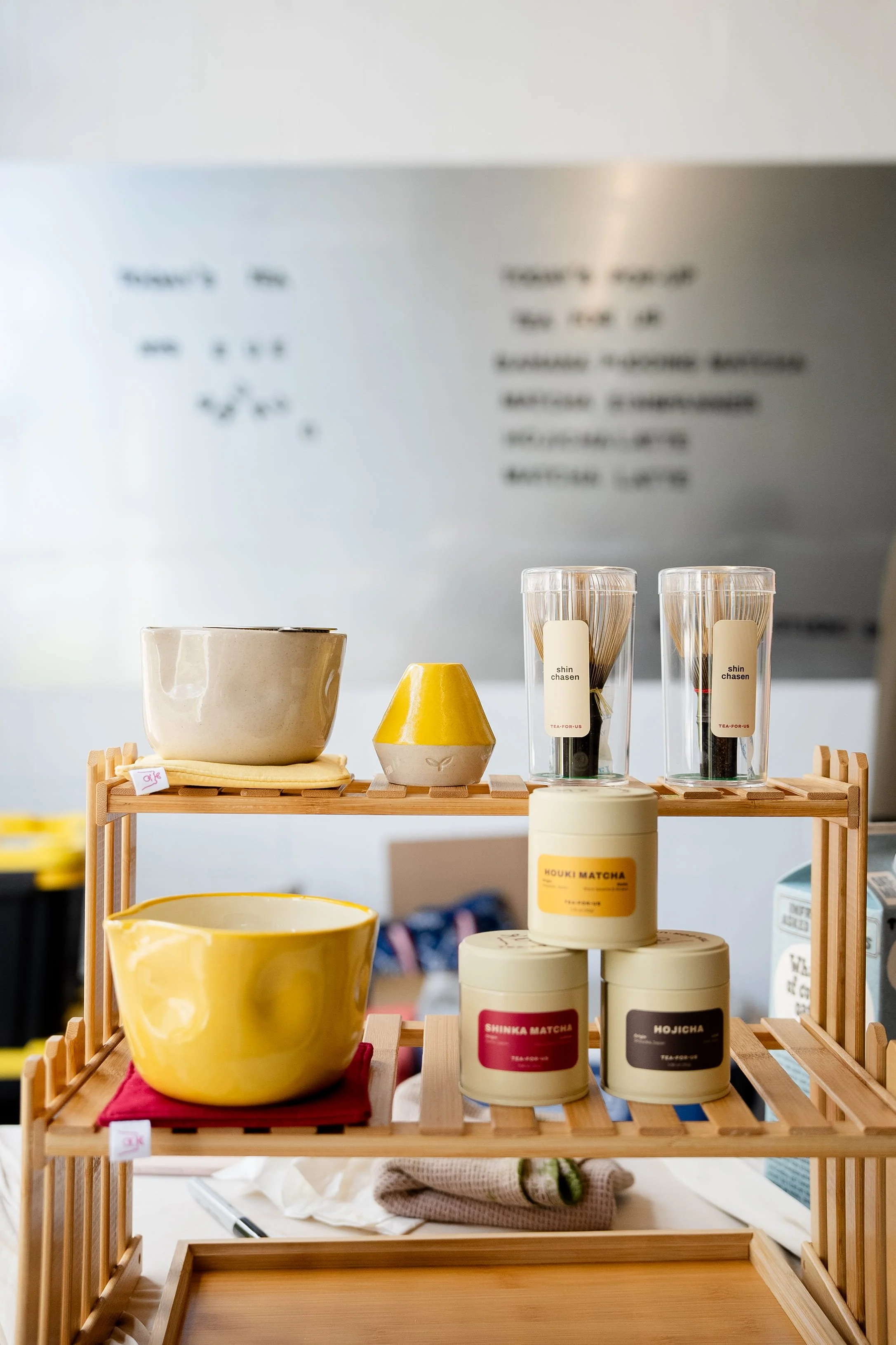 Detail shot of matcha tins, handmade matcha bowls, and chasens during a Tea For Us brand activation pop-up with Kindred Studio in San Francisco