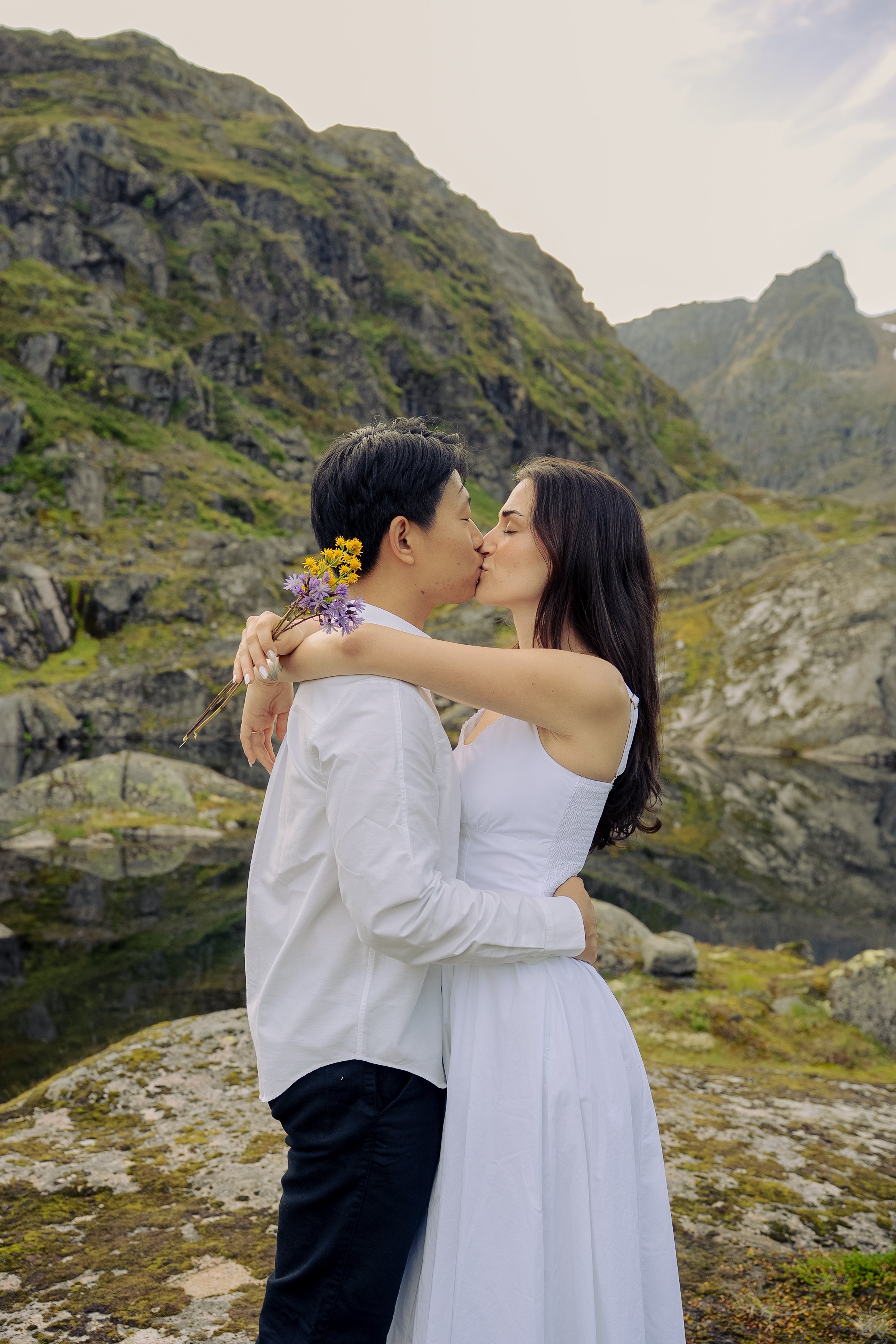 Whimsical fairytale engagement photoshoot featuring wildflower bouquet in Lofoten, Norway