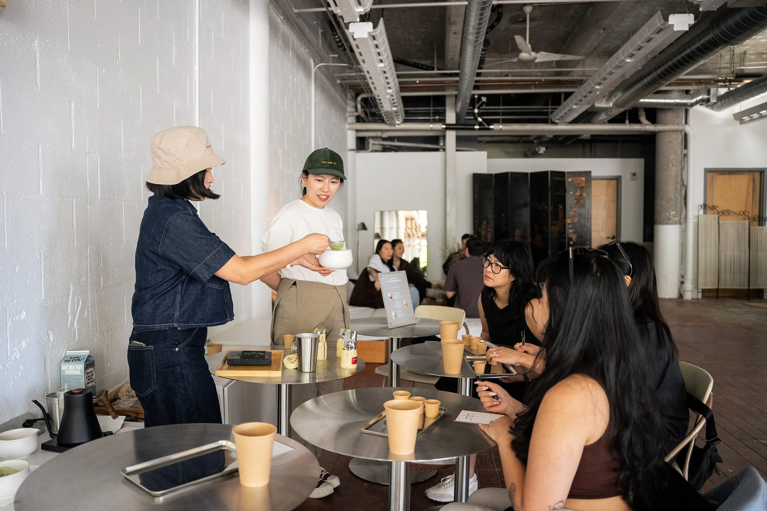 Photo of brand owners leading a matcha tasting during a Tea For Us brand activation pop-up with Kindred Studio in San Francisco