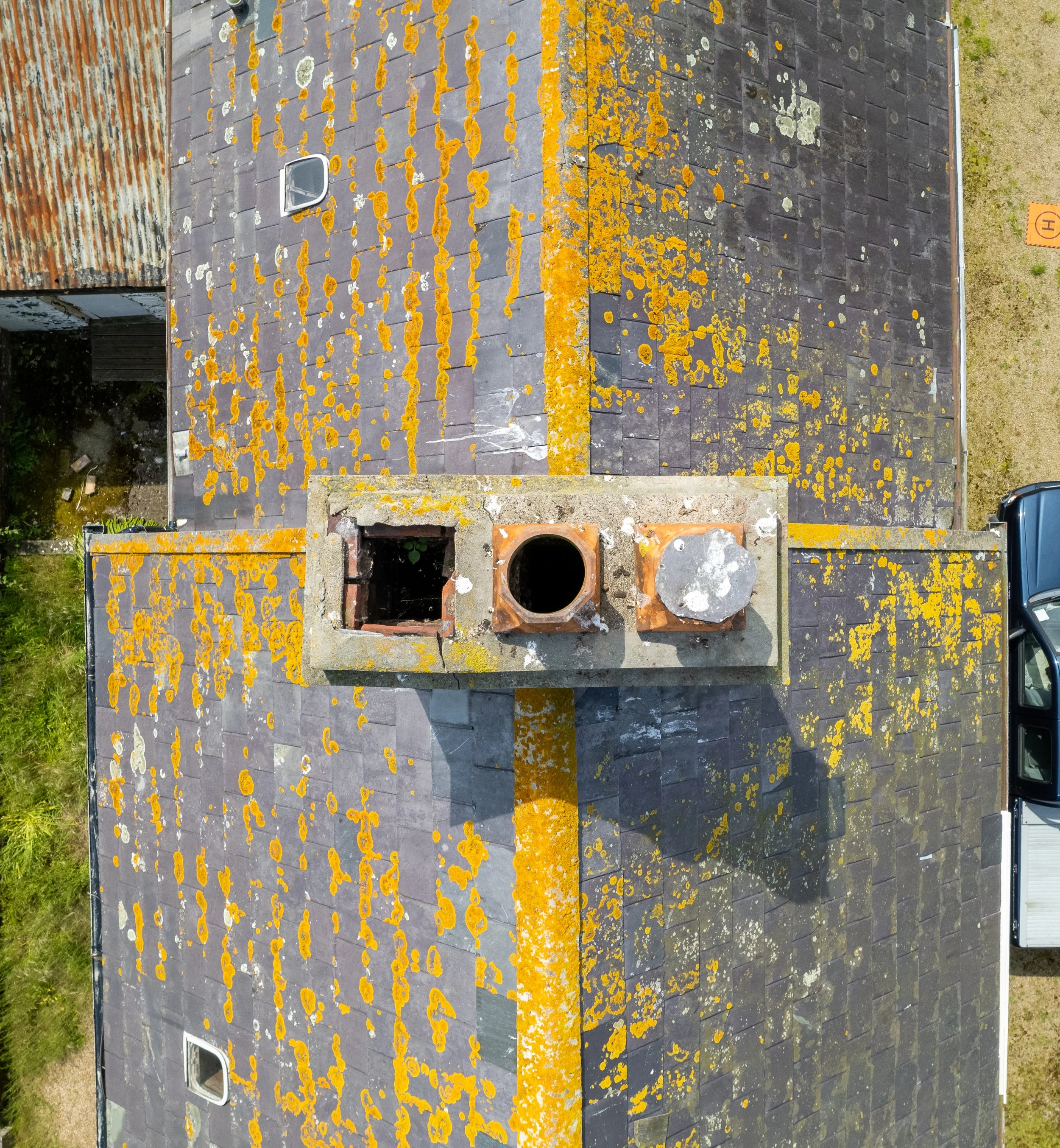 Aerial drone view of a Channel Islands roof showing chimney and flashing detail