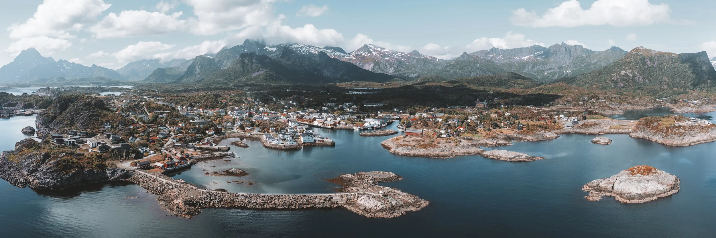 Aerial panoramic view of Kabelvåg in the Lofoten Islands, Norway, with mountains, sea, islands and coastal homes.