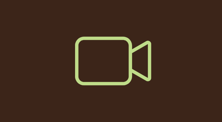 Icon van een videocamera op een bruin achtergrond.