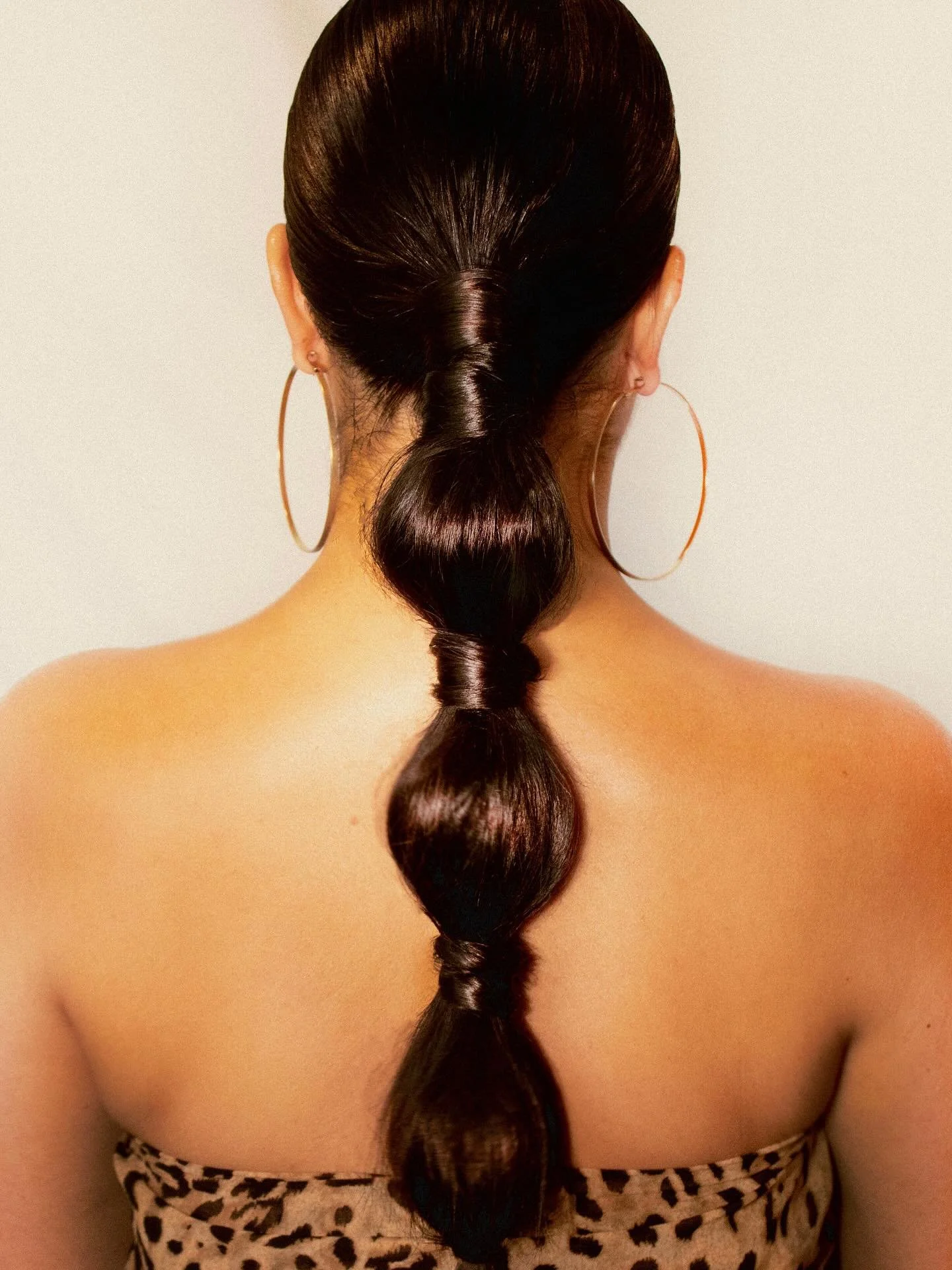 Sleek bubble ponytail with glossy finish by professional hairstylist Mollie Barnard | editorial hair UK.