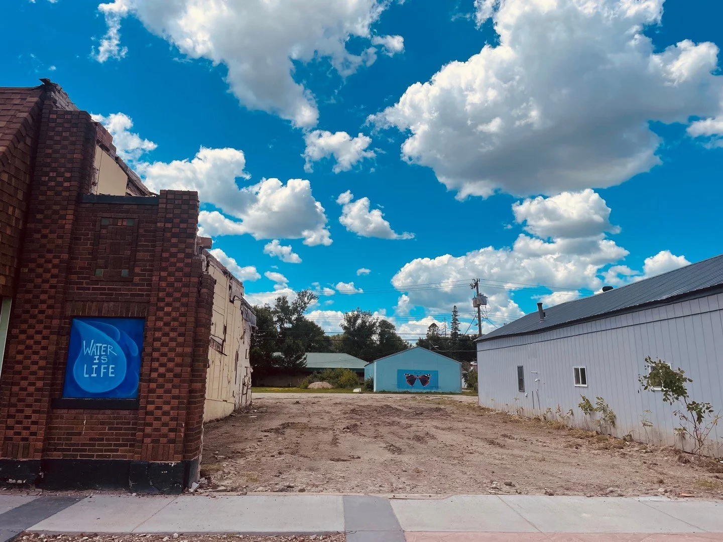 Now and Then

New view of the Mahnomen Red Admiral butterfly spot after the loss of the historic  of Rainbow theatre demolished in June 2025.  We've been looking back at one of our early art installations in atom as well as some photos of the theater