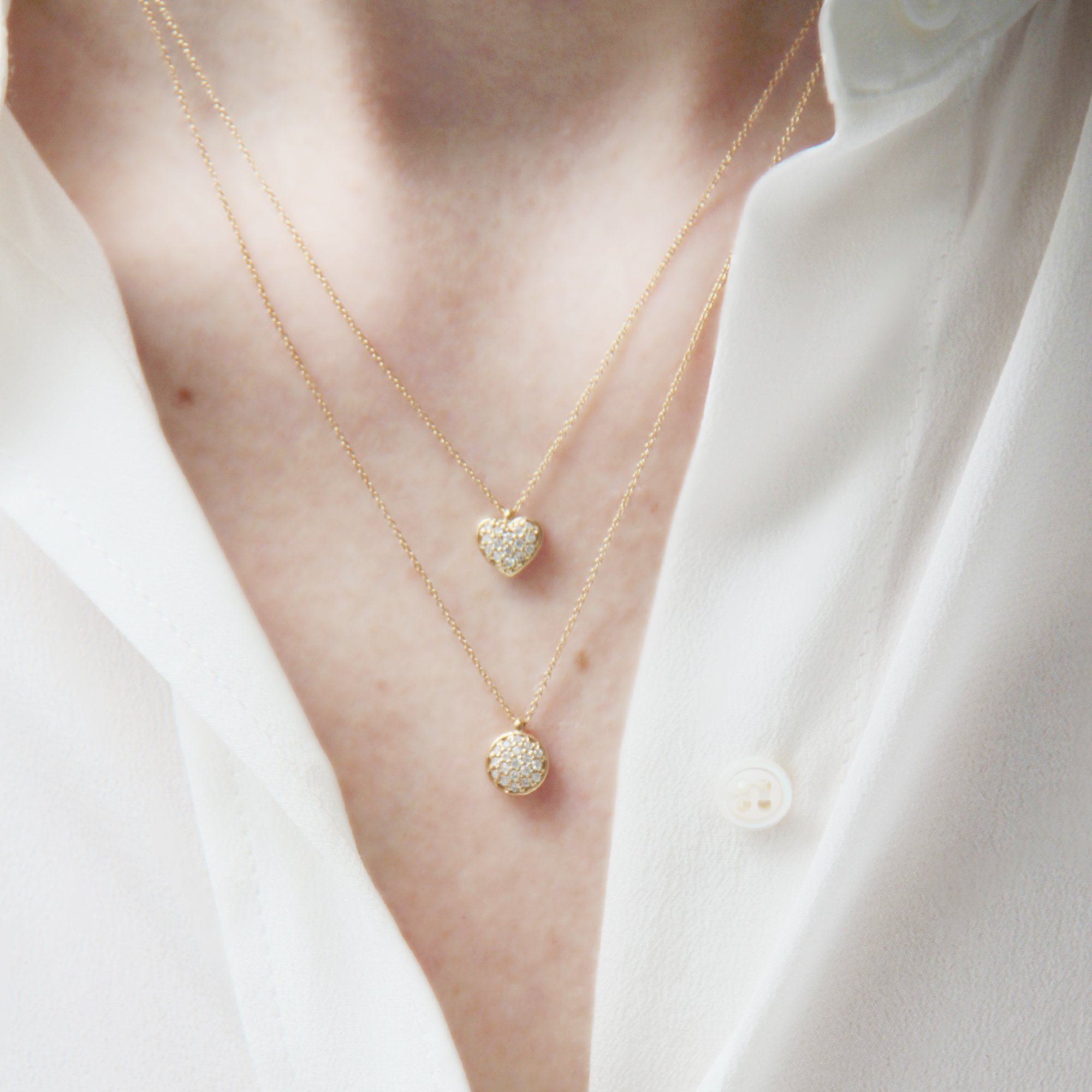 Gold Pave Set Diamond Dot and Diamond Heart Necklaces shown being worn