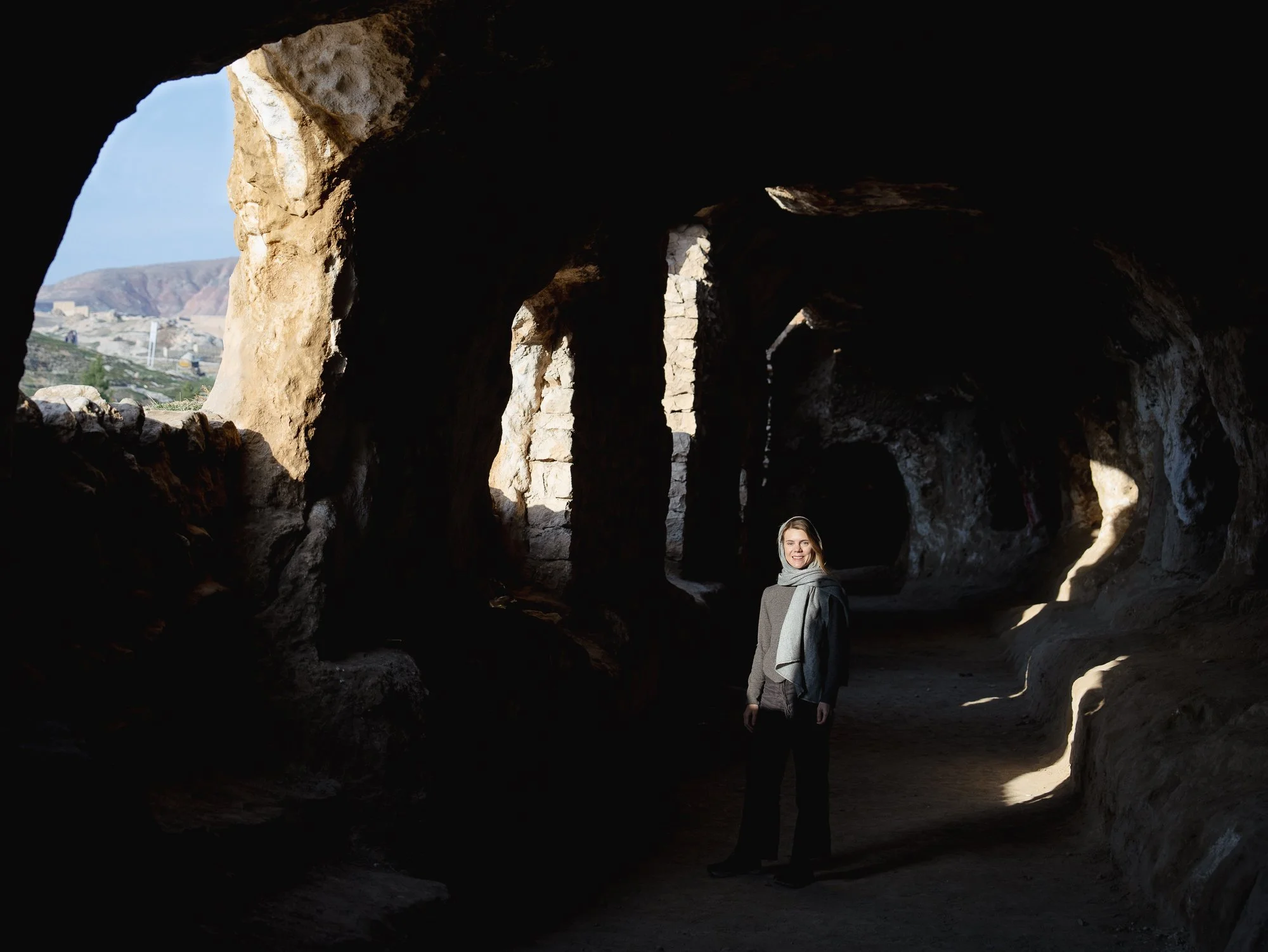 At the base of the hill at Takht-e Rostam lies a second, lesser-known but equally important part of the Buddhist complex, distinct from the rock-cut stupa at the summit. This lower complex consists of a series of caves, tunnels, and chambers carved h