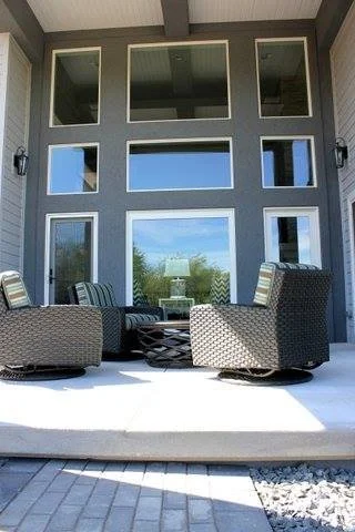 Large windows with outdoor patio and chairs