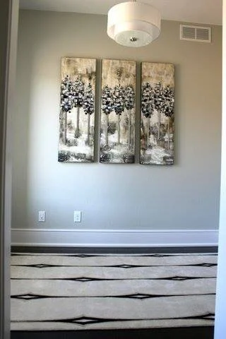 Hallway with three paneled canvas art