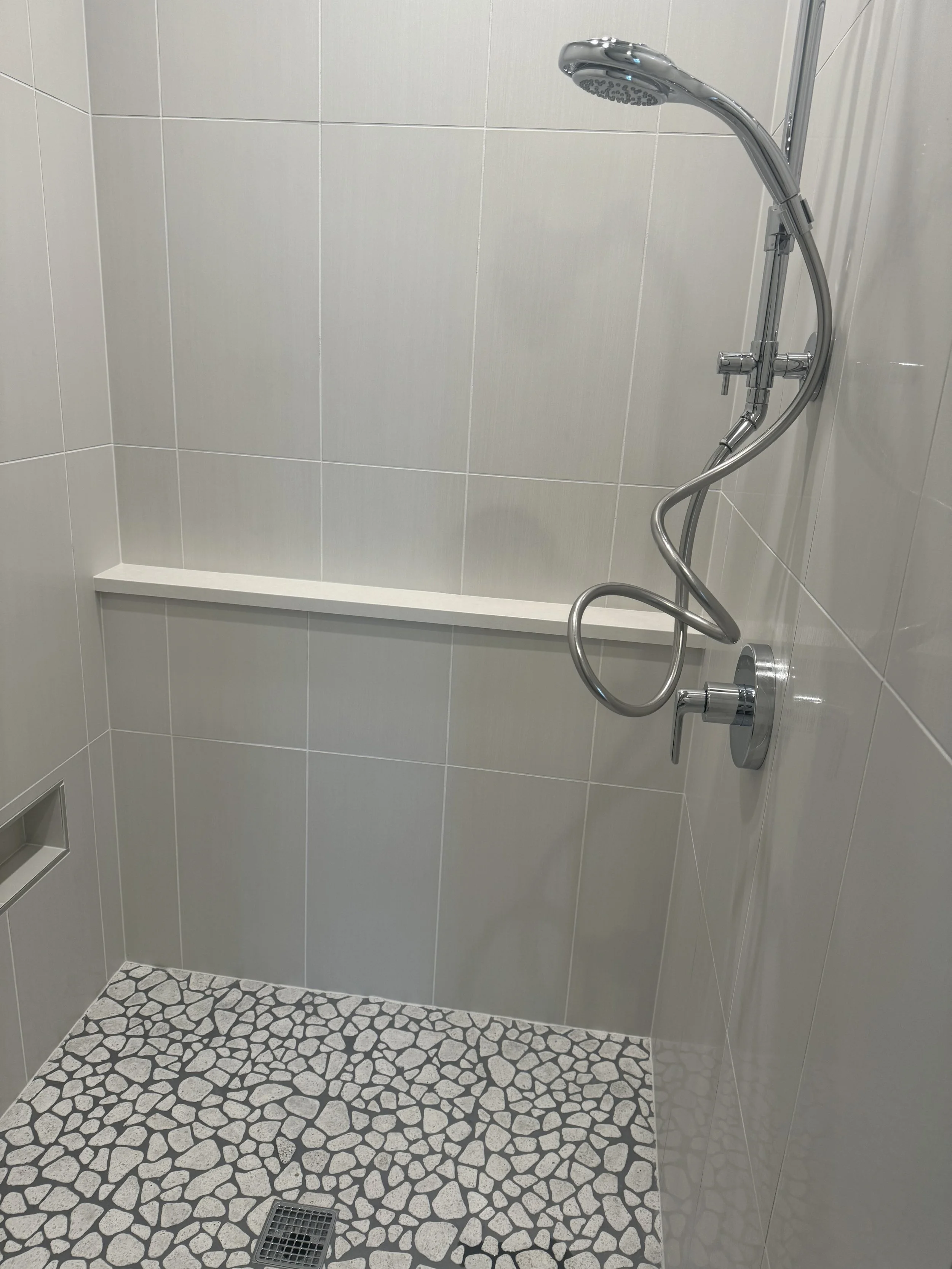 Shower with river rock flooring