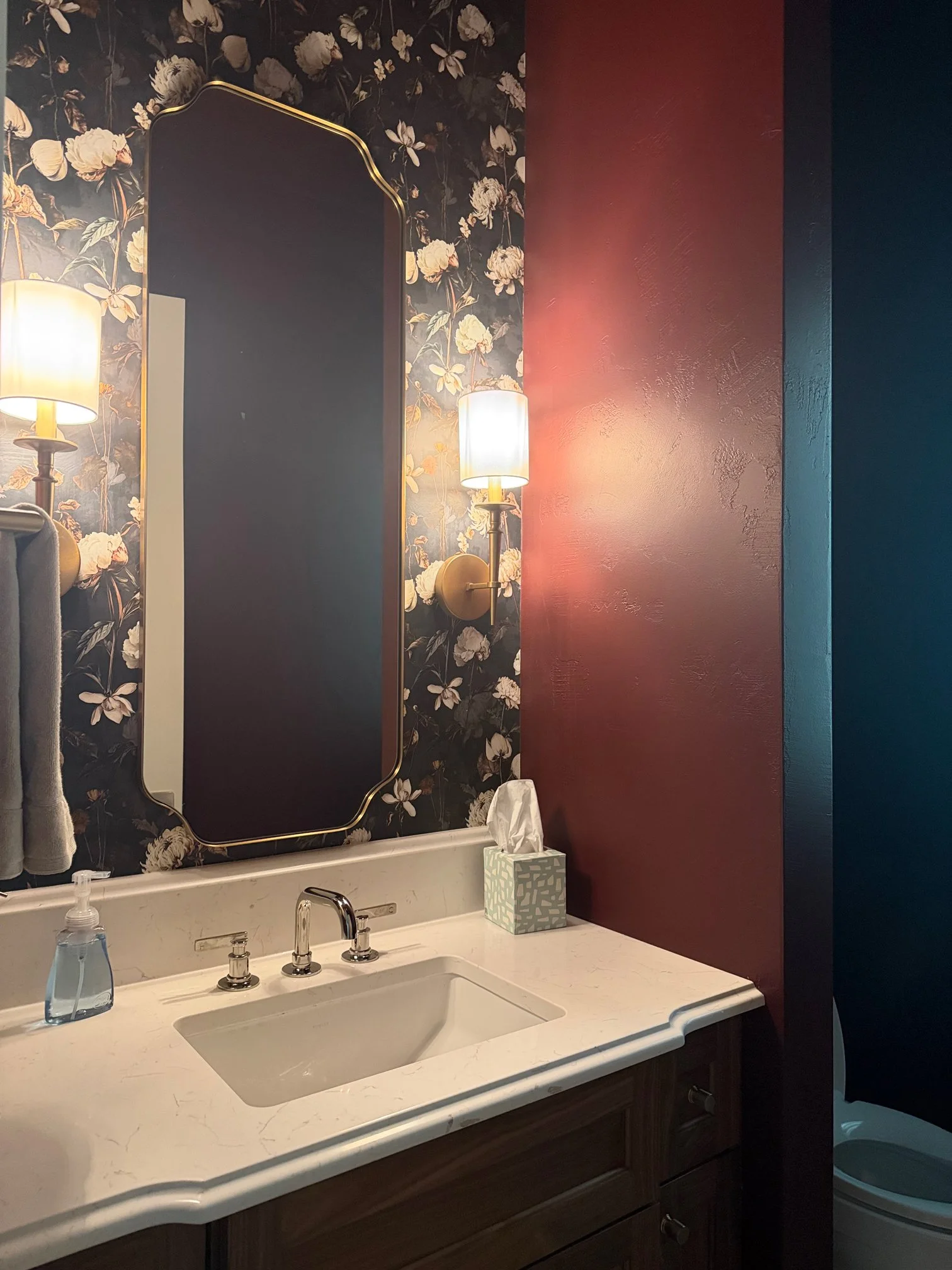 Powder room with moody floral wallpaper