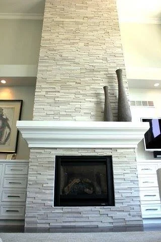 Floor to ceiling tiled fireplace with mantle