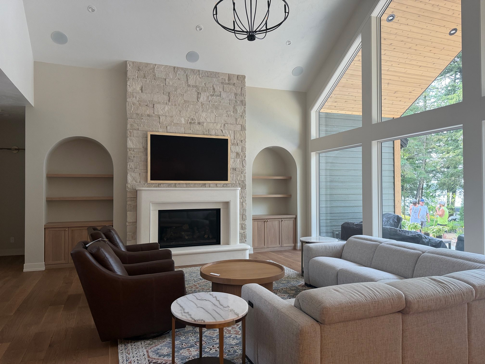 Living room stone fireplace with built-in shelving