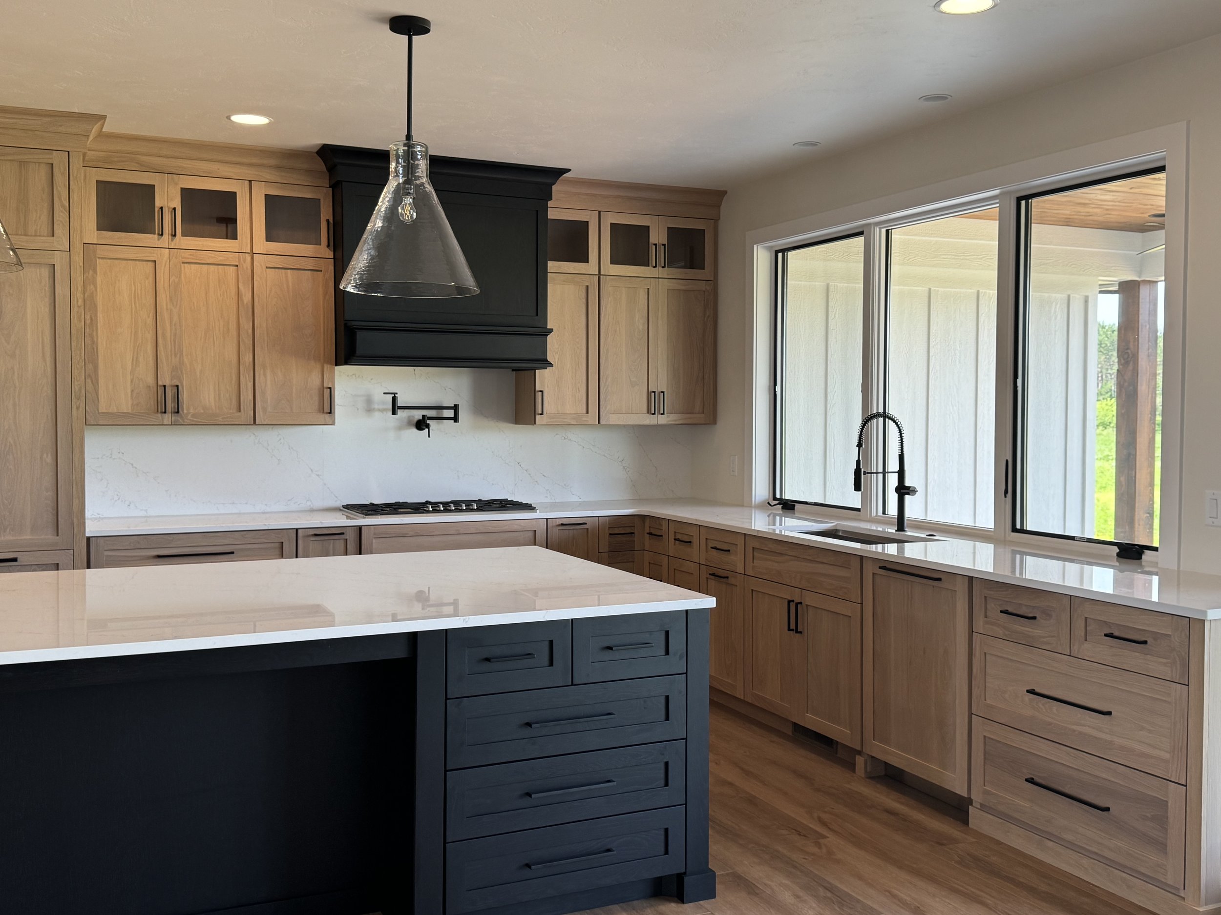 Modern farmhouse kitchen with black island