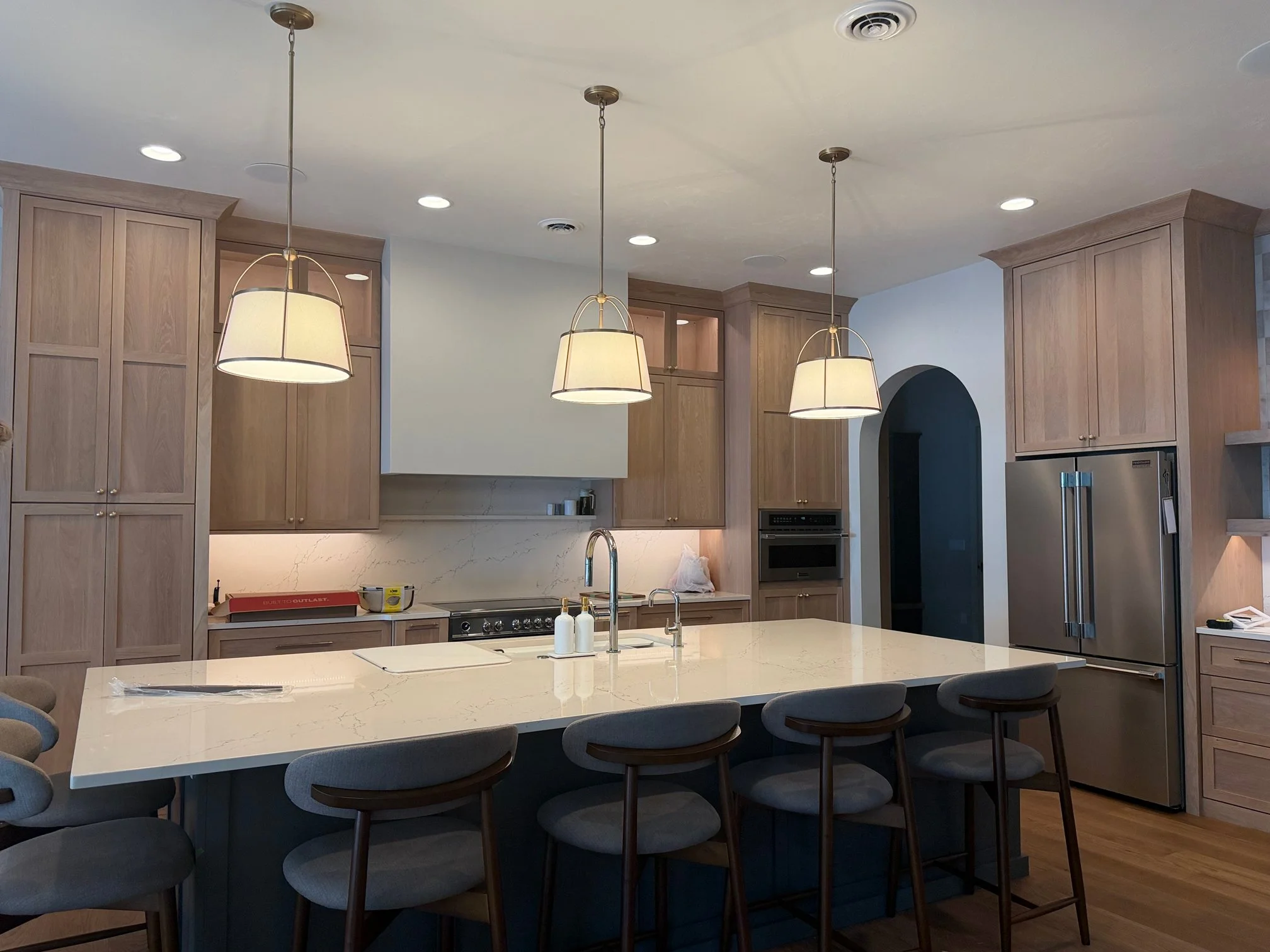 Kitchen island with pendant lighting in new construction
