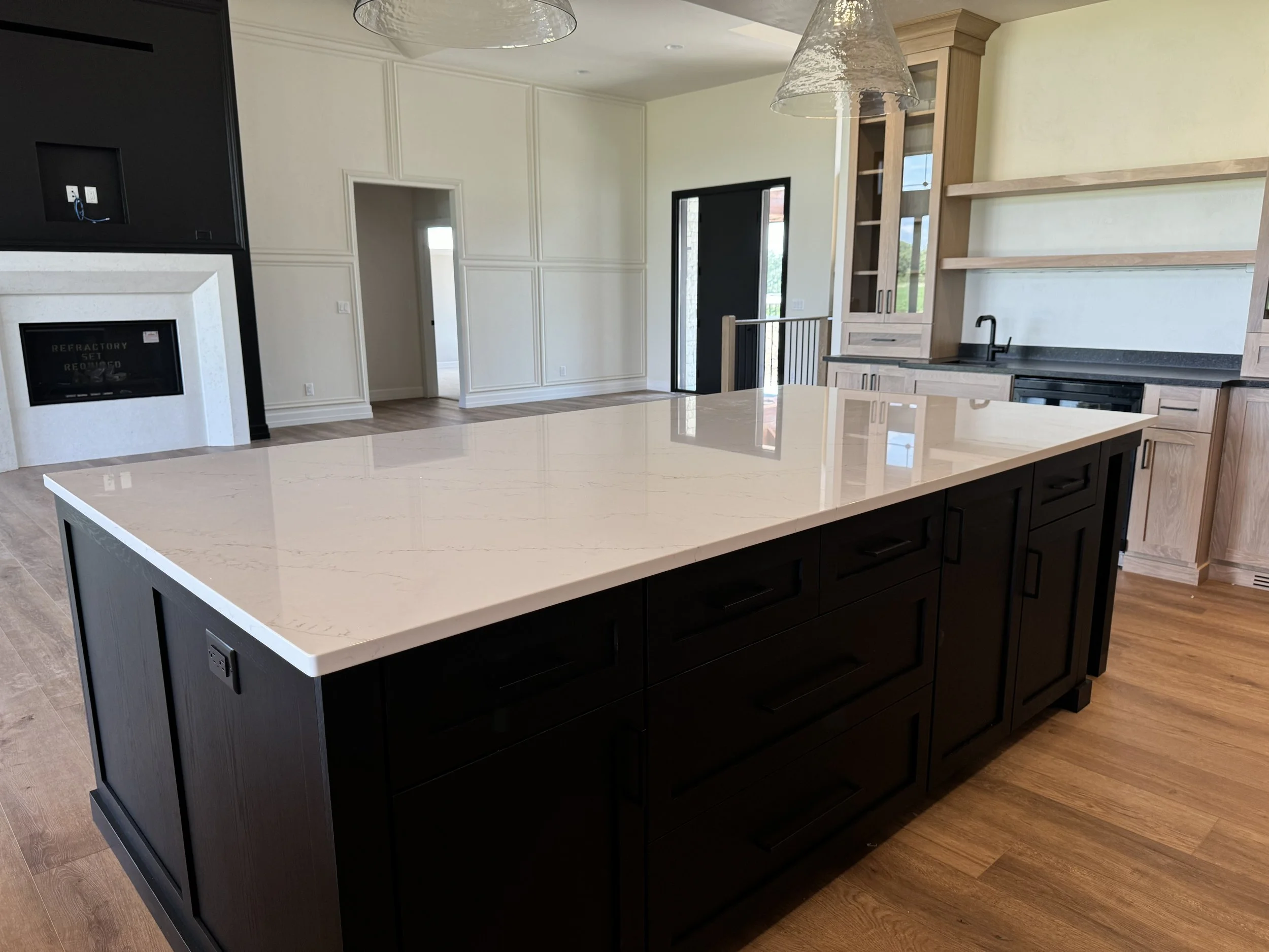 Black kitchen island with white countertop
