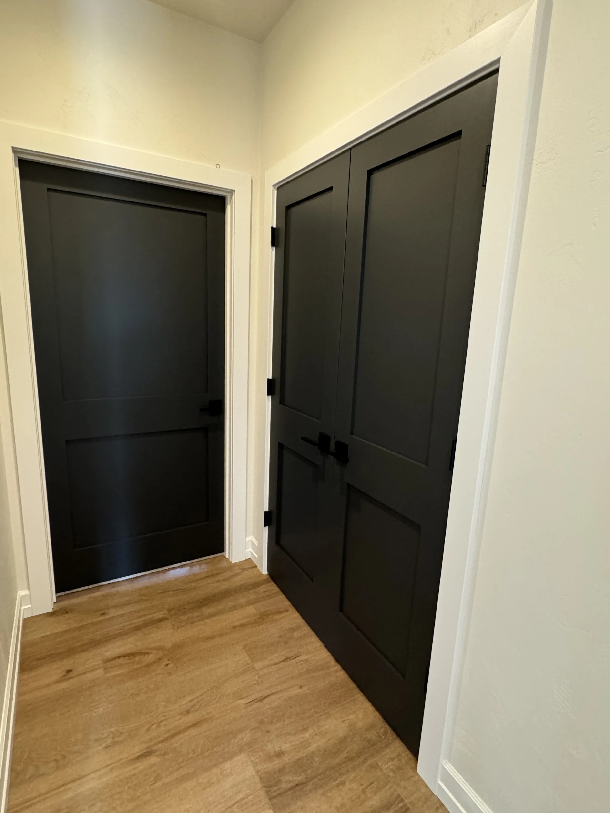 Hallway with black doors