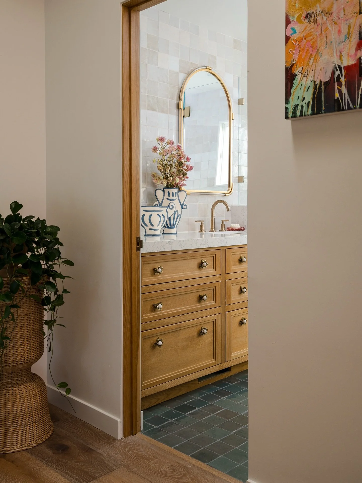 Project Los Alamos and another dreamy space we love the final look and function of. This shared bathroom designed for two sisters — layered in creamy white and eucalyptus green zellige tile, custom white oak cabinetry, and the sweetest hardware