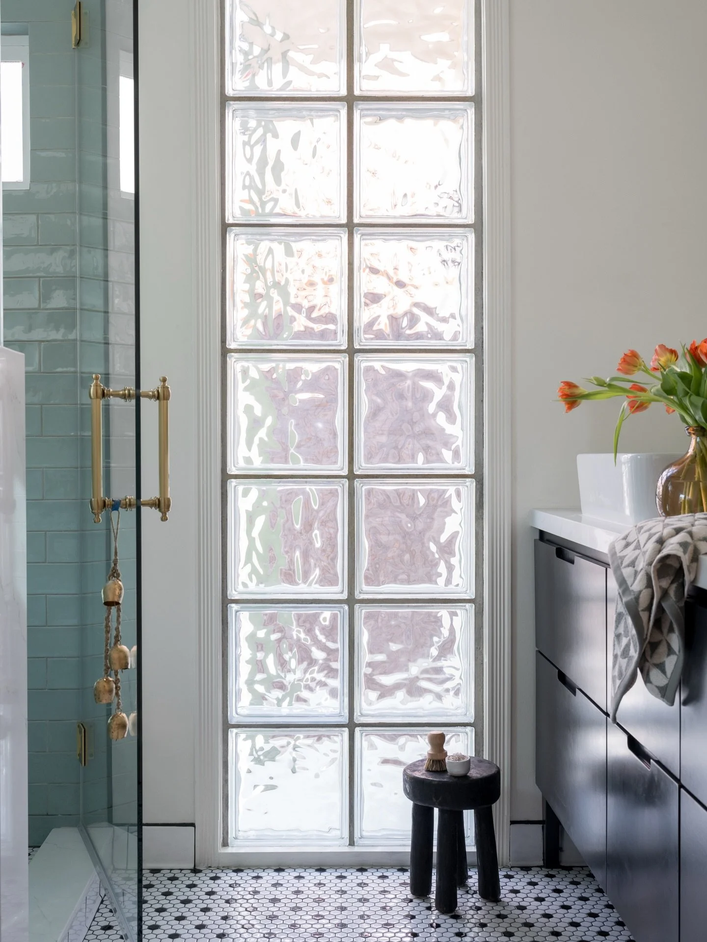 Small footprint, big personality. This Southern California bathroom renovation packs in glass block, ocean blue tile, classic penny round floors, and clever built-in storage tucked into every corner &mdash; because SoCal square footage doesn&rsquo;t 
