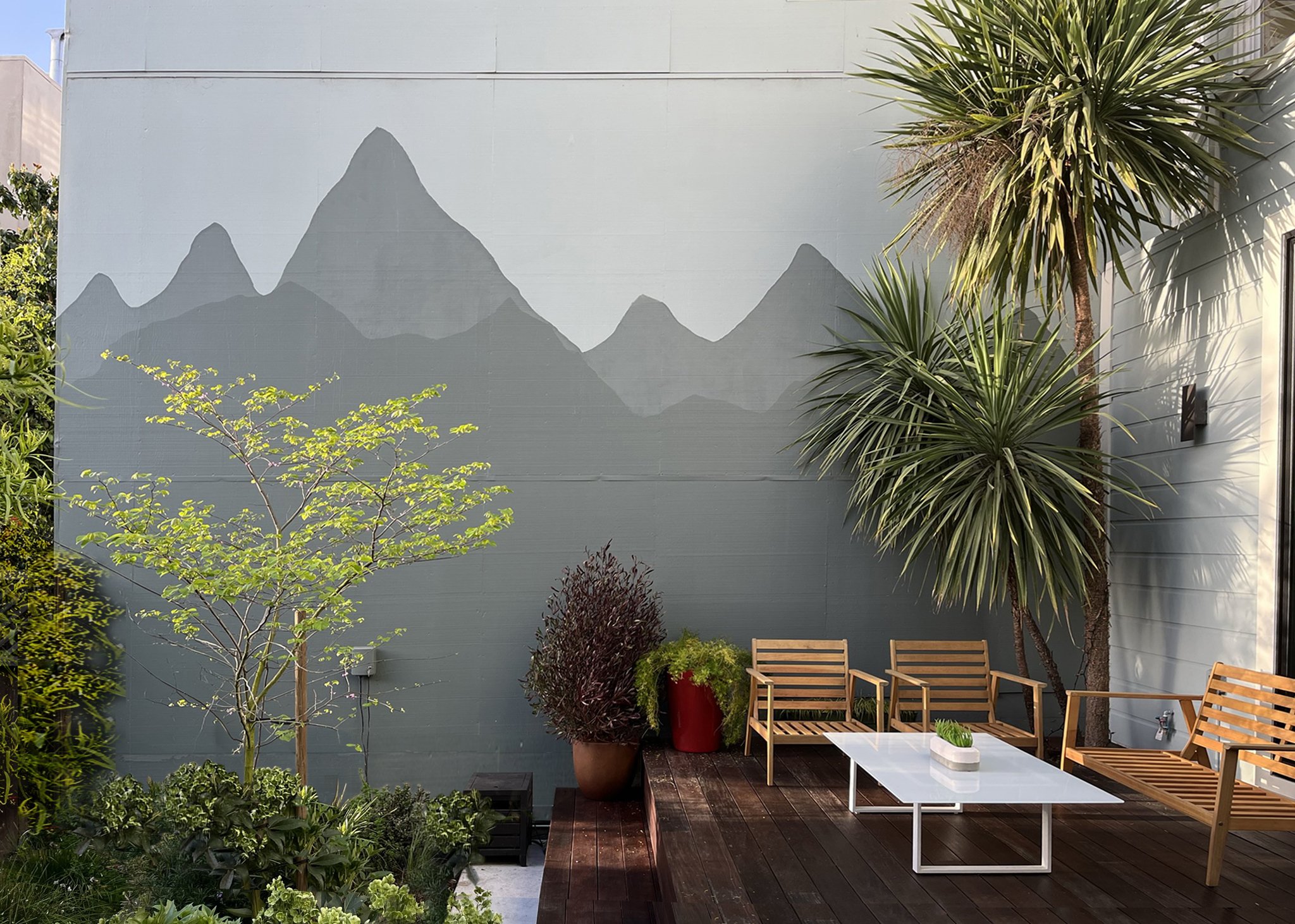 simple mountain mural backdrops the deck and garden
